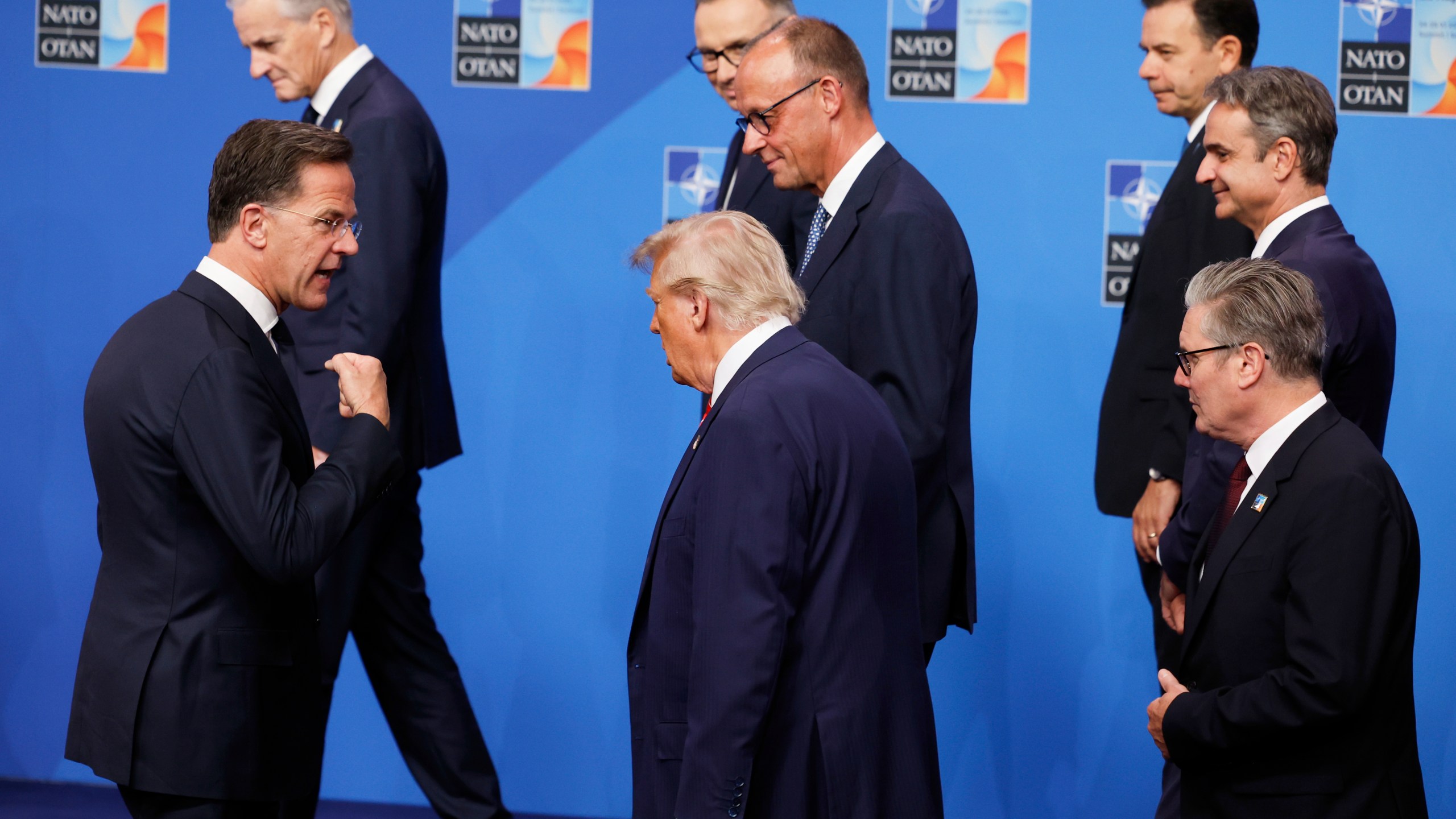 NATO Secretary General Mark Rutte, left, speaks with President Donald Trump, center, and Britain's Prime Minister Keir Starmer, right, after a group photo of NATO heads of state and government at the NATO summit in The Hague, Netherlands, Wednesday, June 25, 2025. (AP Photo/Geert Vanden Wijngaert)