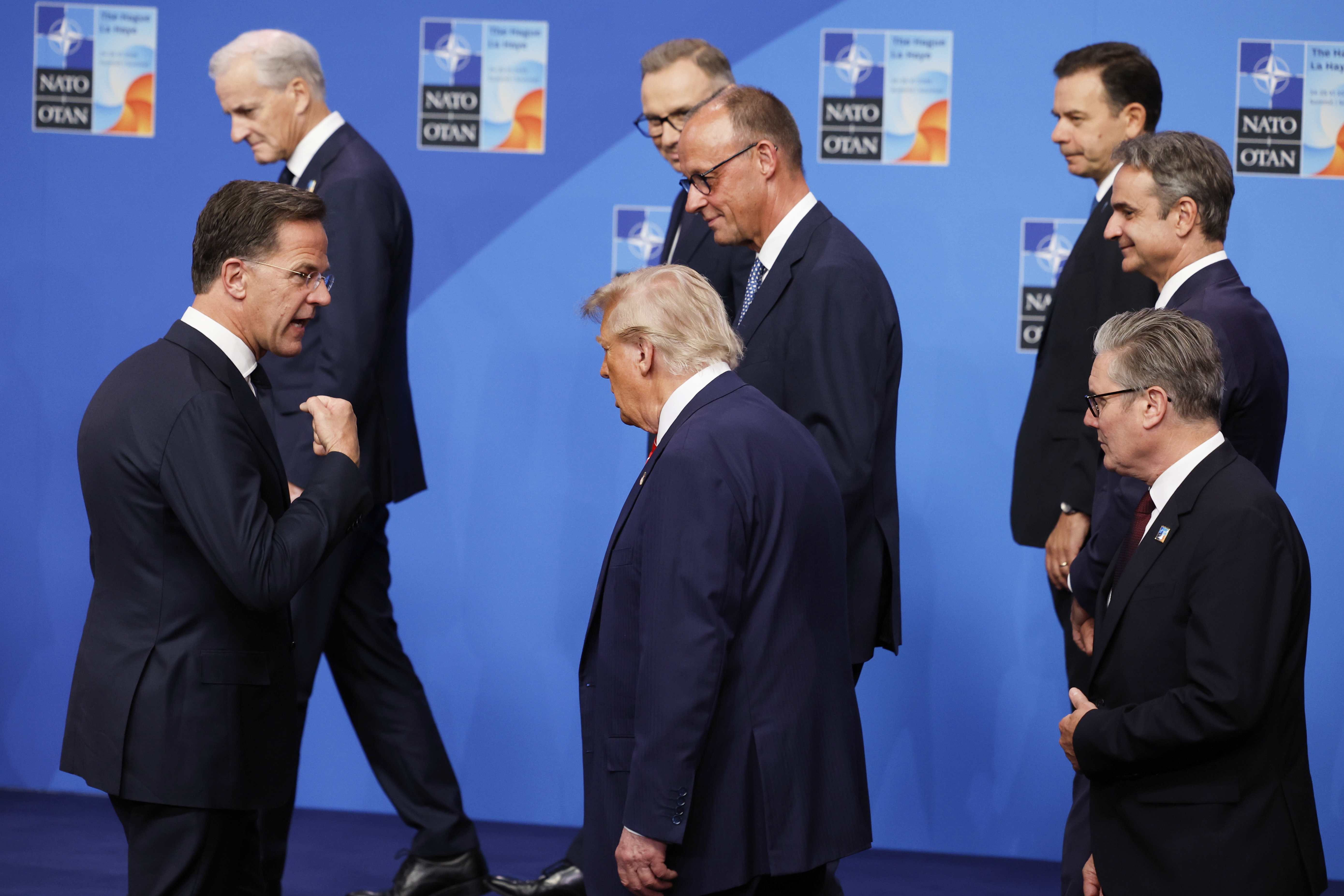 NATO Secretary General Mark Rutte, left, speaks with President Donald Trump, center, and Britain's Prime Minister Keir Starmer, right, after a group photo of NATO heads of state and government at the NATO summit in The Hague, Netherlands, Wednesday, June 25, 2025. (AP Photo/Geert Vanden Wijngaert)
