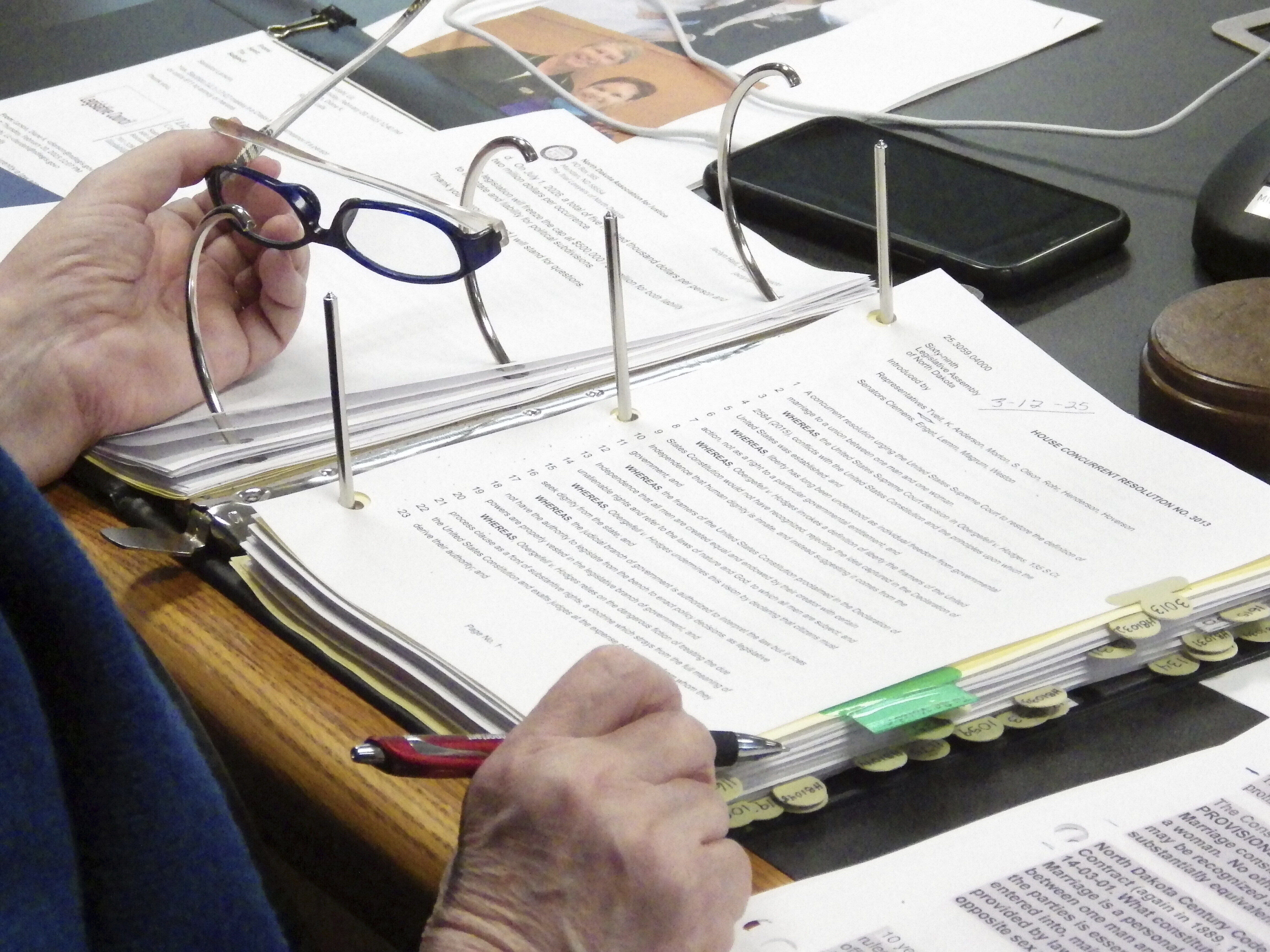 FILE - North Dakota Republican Sen. Diane Larson looks at a resolution that would urge the U.S. Supreme Court to overturn its 2015 decision that legalized same-sex marriage nationwide, March 12, 2025, at the state Capitol in Bismarck, N.D. (AP Photo/Jack Dura, File)