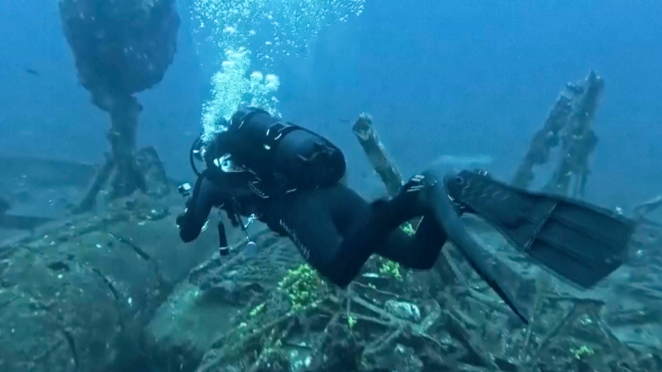 In this frame grab made from video, diver Toni Kuran swims by the wreck of a sunken 18th-century boat after it was discovered by chance in April near the stone walls of Croatia’s medieval city of Dubrovnik, Croatia, Tuesday, June 24, 2025. (Nova TV via AP)