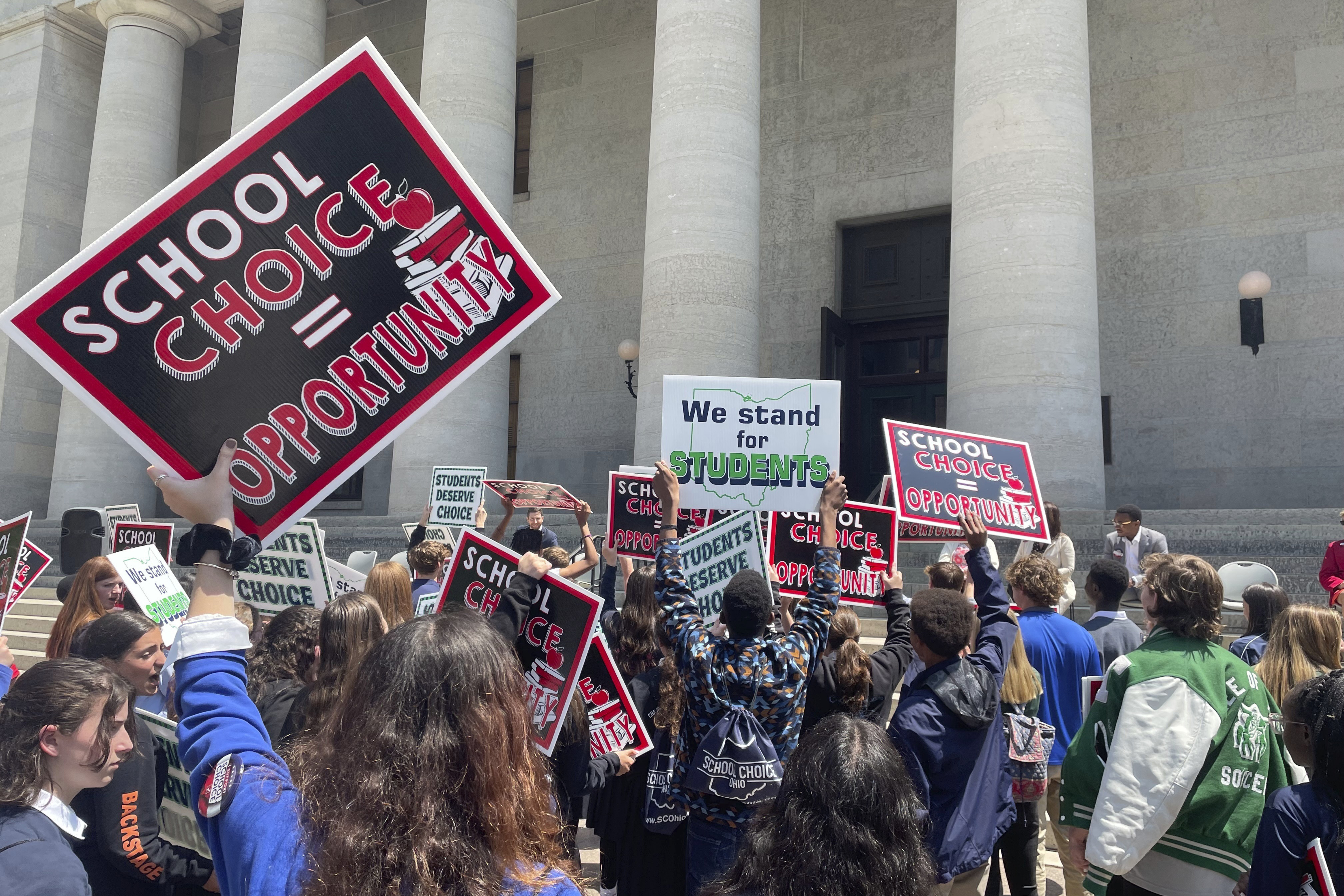 FILE - Students and parents rally at the Ohio Statehouse in support of possible changes that would increase eligibility for taxpayer-funded school vouchers to K-12 students statewide, May 17, 2023, in Columbus, Ohio. (AP Photo/Samantha Hendrickson, File)