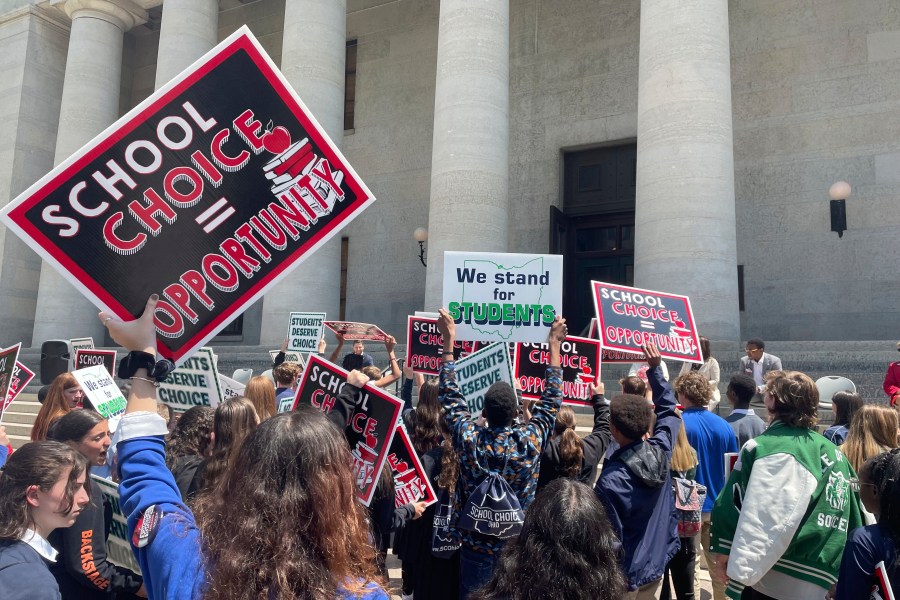 FILE - Students and parents rally at the Ohio Statehouse in support of possible changes that would increase eligibility for taxpayer-funded school vouchers to K-12 students statewide, May 17, 2023, in Columbus, Ohio. (AP Photo/Samantha Hendrickson, File)