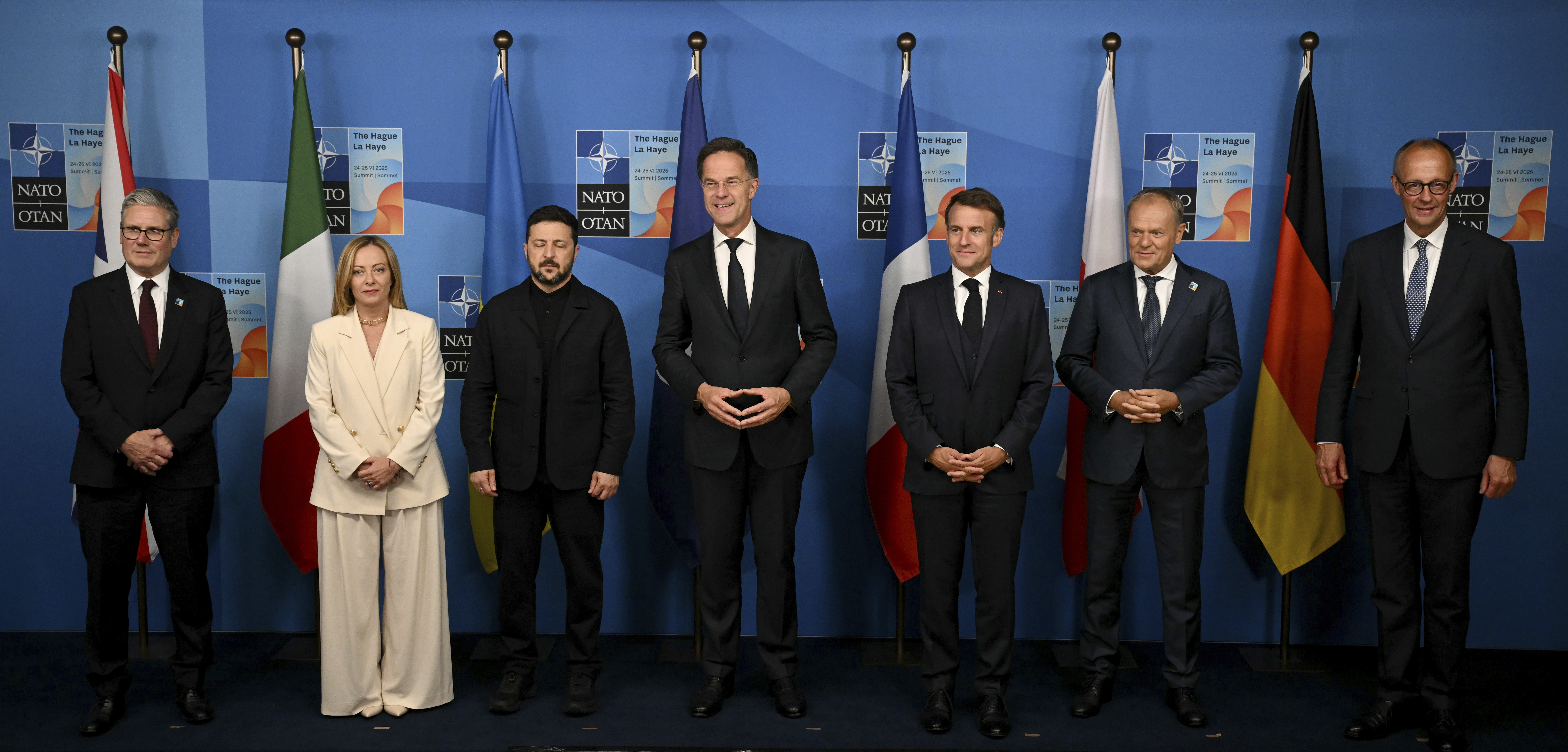 Britain's Prime Minister Keir Starmer, from left, Italy's Prime Minister Giorgia Meloni, Ukraine's President Volodymyr Zelenskyy, NATO Secretary General Mark Rutte, France's President Emmanuel Macron, Poland's Prime Minister Donald Tusk and Germany's Chancellor Friedrich Merz pose for a family picture during the meeting between the Nato secretary general and Ukrainian president with leaders of E5 Group on the sideline of the NATO summit in The Hague, Netherlands, Wednesday, June 25, 2025. (Ben Stansall/Pool Photo via AP)