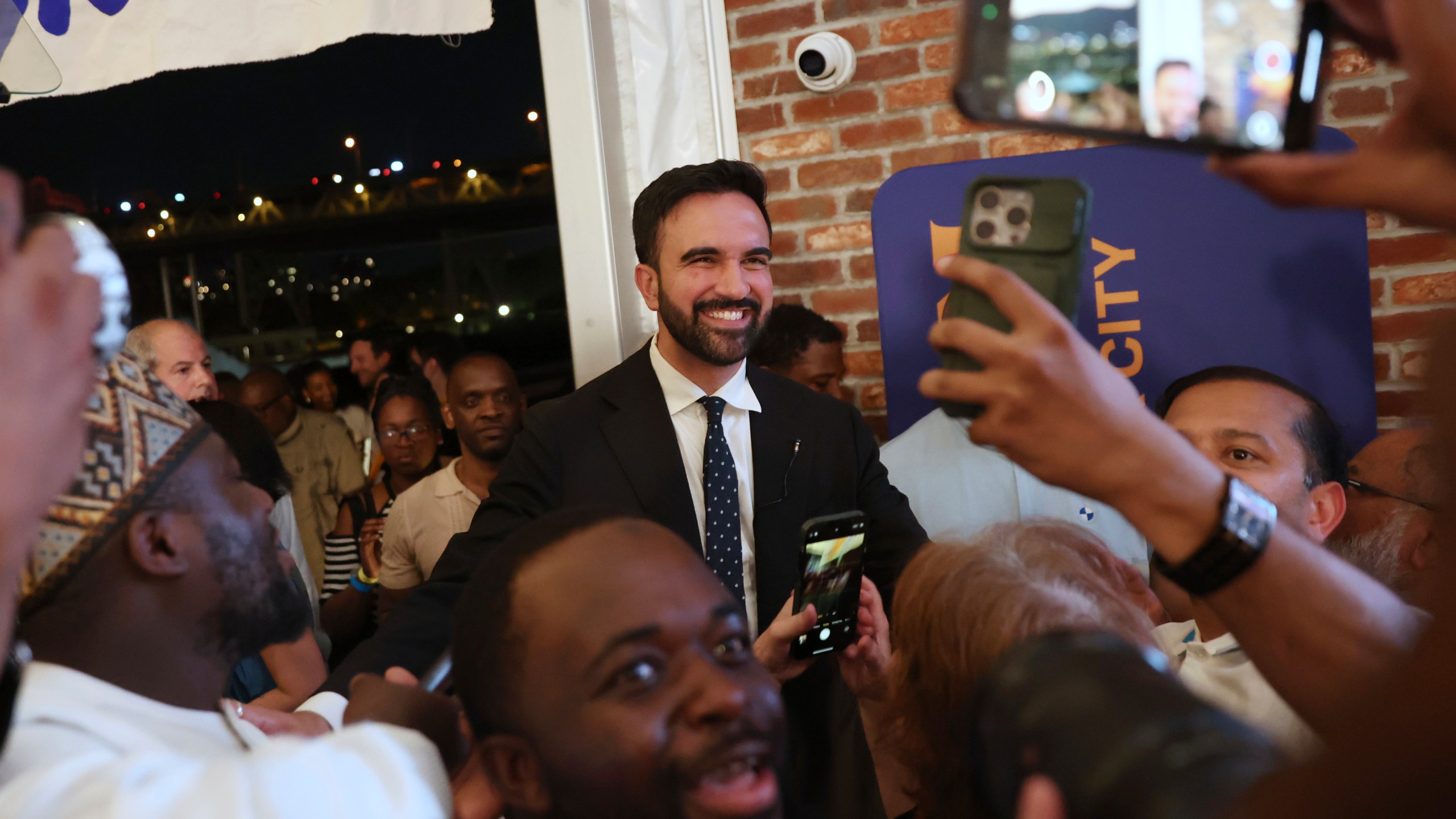 Democratic mayoral candidate Zohran Mamdani takes selfies with supporters after speaking at his primary election party, Wednesday, June 25, 2025, in New York. (AP Photo/Heather Khalifa)