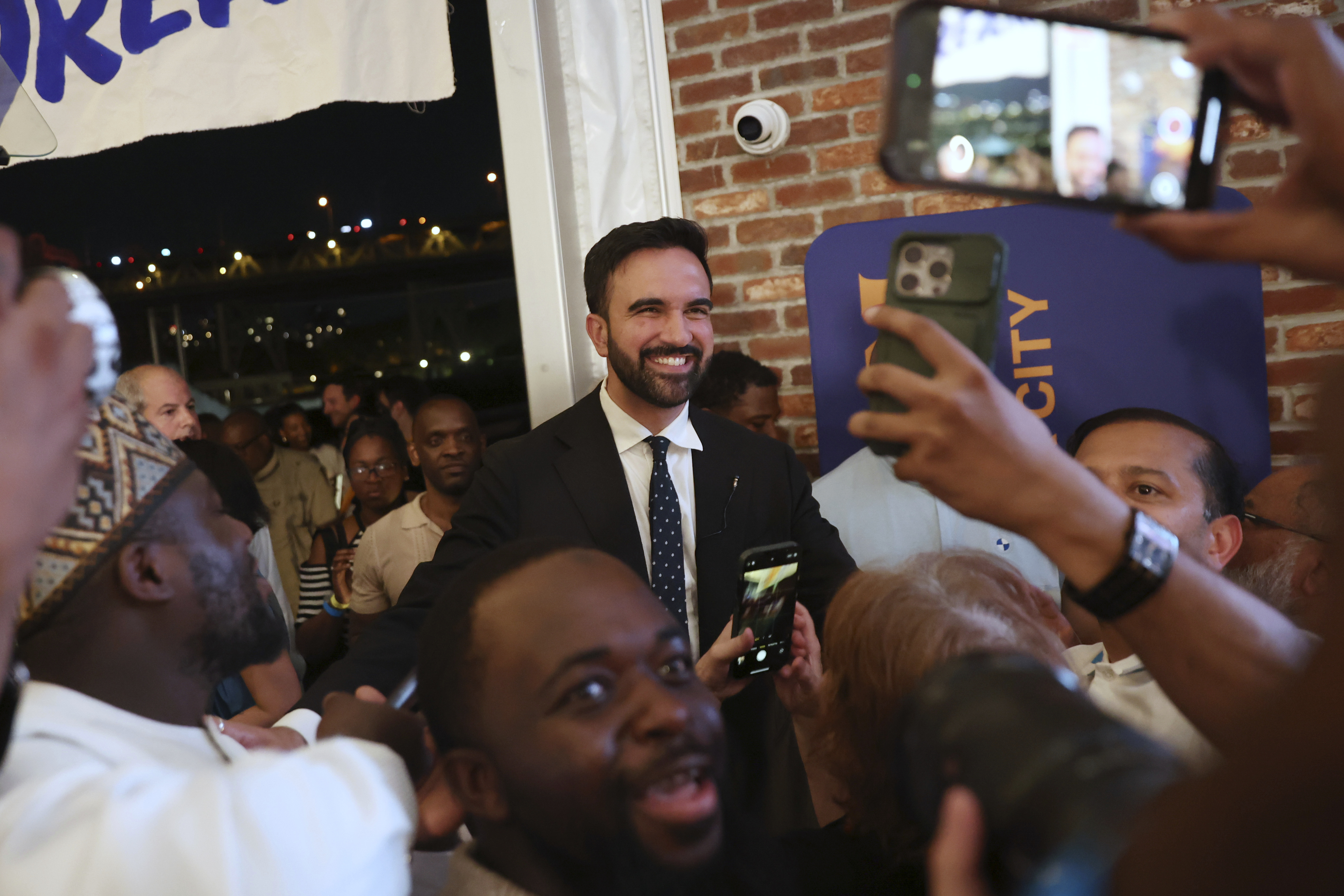 Democratic mayoral candidate Zohran Mamdani takes selfies with supporters after speaking at his primary election party, Wednesday, June 25, 2025, in New York. (AP Photo/Heather Khalifa)