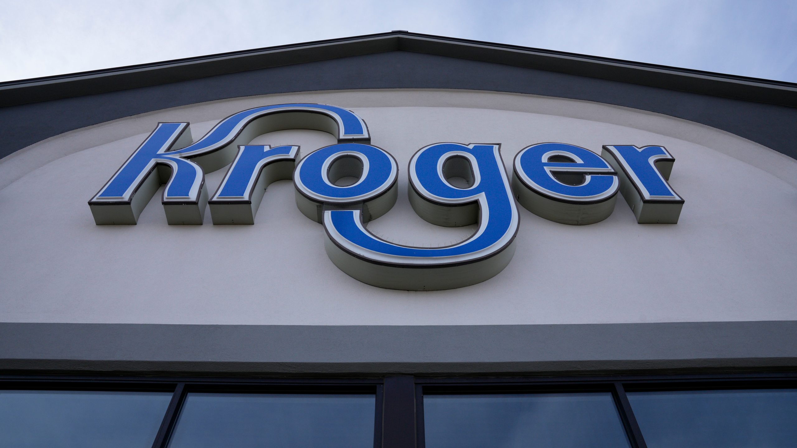 FILE - A sign is affixed to the exterior of a Kroger grocery store in Monroe, Ohio, in this undated photo. (AP Photo/Jeff Dean, File)