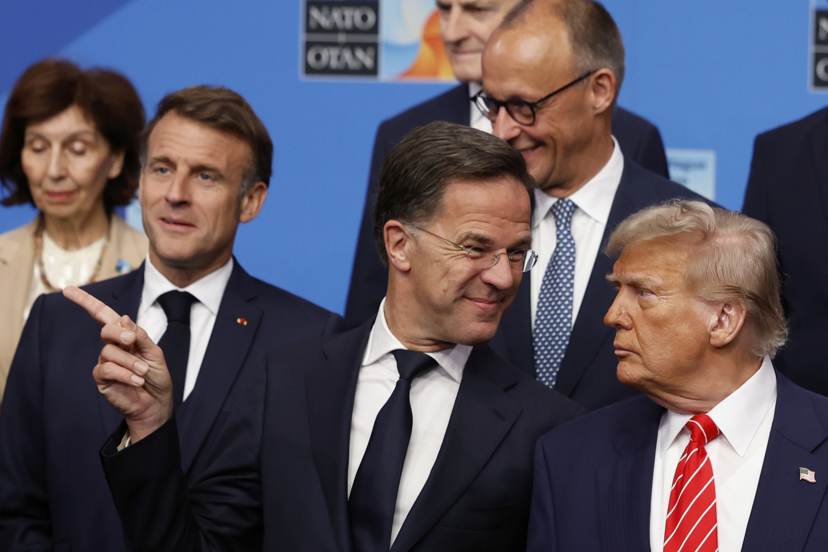 President Donald Trump, right, speaks with NATO Secretary General Mark Rutte during a group photo of NATO heads of state and government at the NATO summit in The Hague, Netherlands, Wednesday, June 25, 2025. (AP Photo/Geert Vanden Wijngaert)