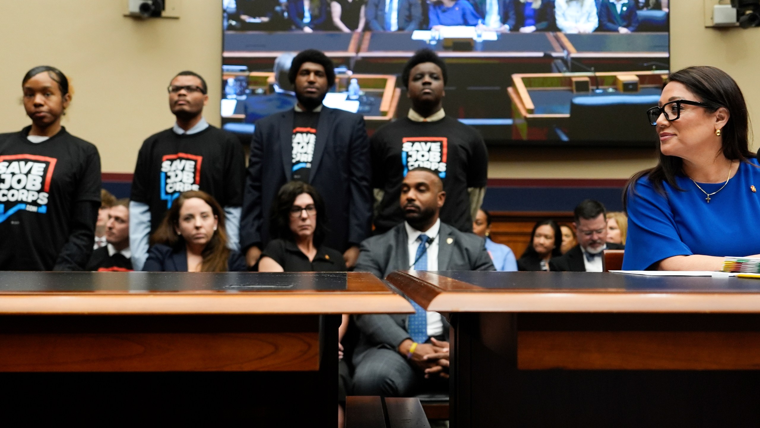 Secretary of Labor Lori Chavez-DeRemer looks as Job Corps members stand behind her during a House Education and Workforce hearing, Thursday, June 5, 2025, on Capitol Hill in Washington. (AP Photo/Julia Demaree Nikhinson)