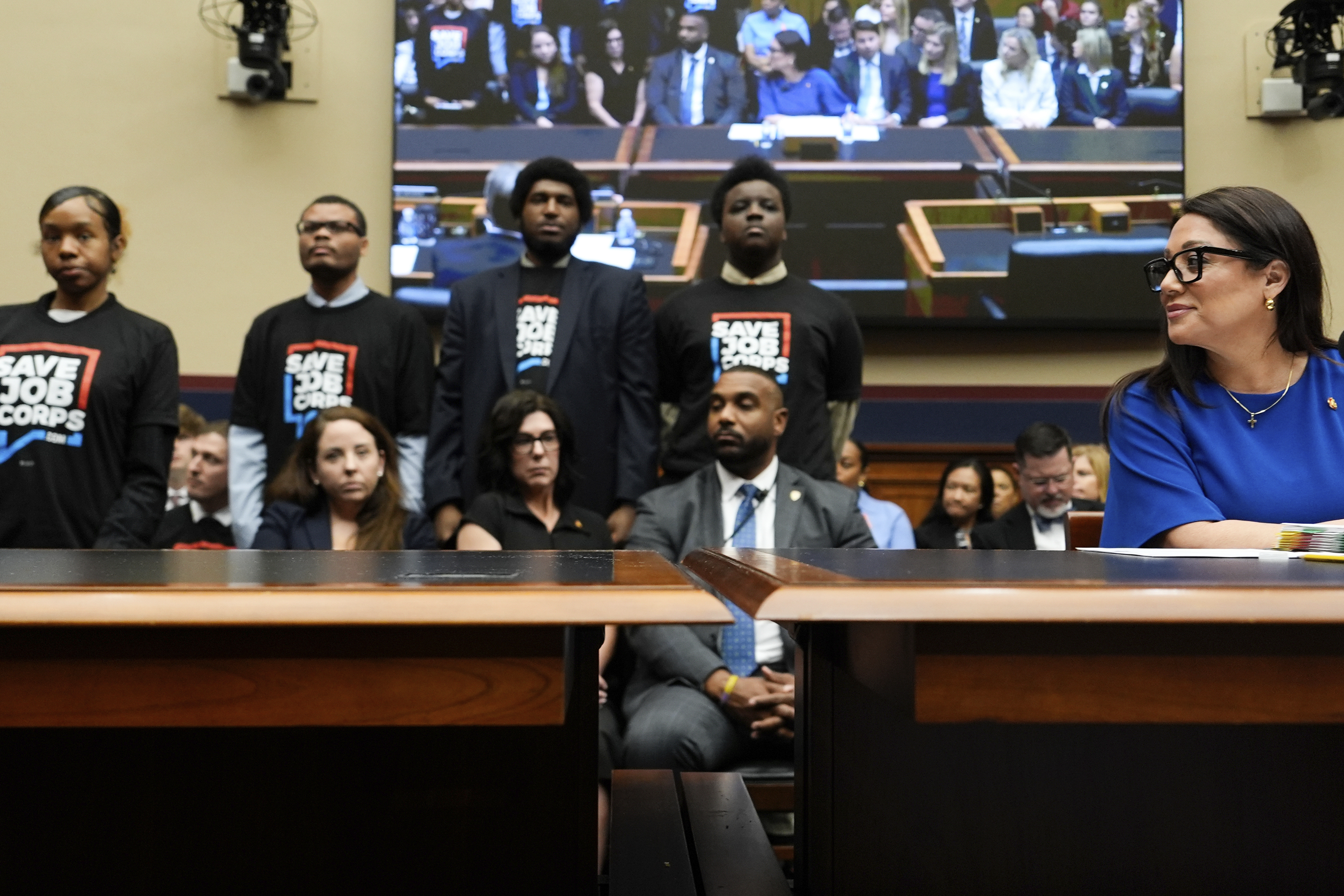 Secretary of Labor Lori Chavez-DeRemer looks as Job Corps members stand behind her during a House Education and Workforce hearing, Thursday, June 5, 2025, on Capitol Hill in Washington. (AP Photo/Julia Demaree Nikhinson)