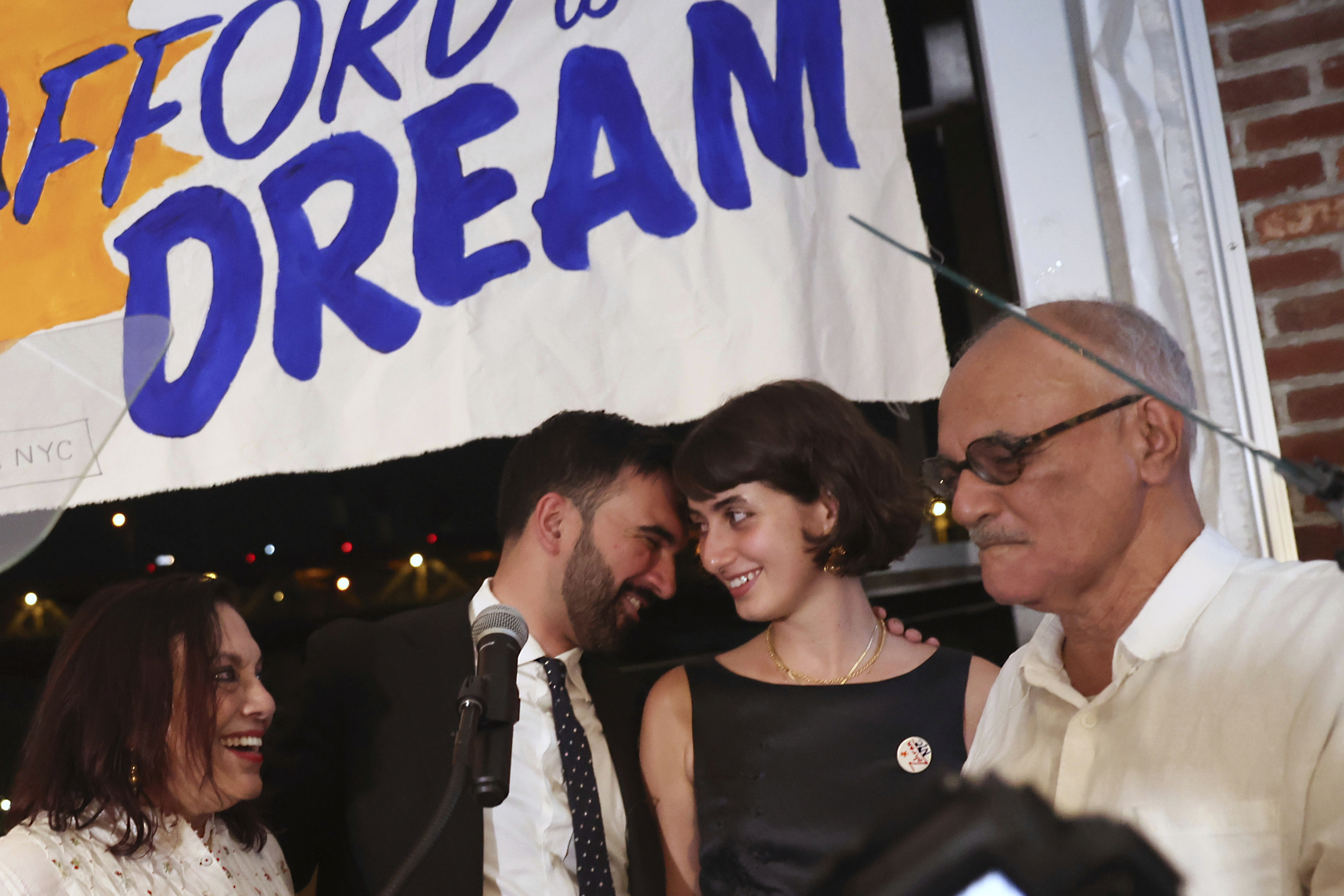 Democratic mayoral candidate Zohran Mamdani, center left, appears on stage with his wife, Rama, mother, Mira Nair Duwaji, left, and father, Mahmood Mamdani, at his primary election party, in New York, Wednesday, June 25, 2025. (AP Photo/Heather Khalifa)
