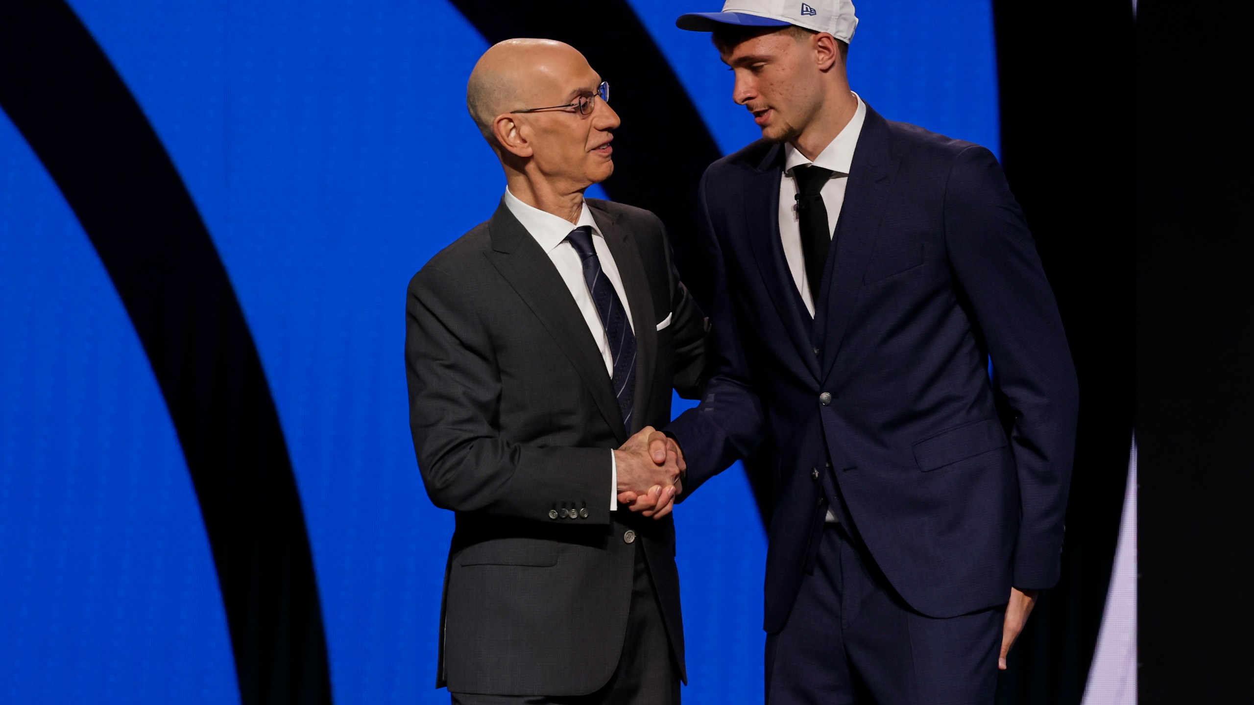 Cooper Flagg, right, shakes hands with NBA commissioner Adam Silver after being selected first overall by the Dallas Mavericks In the first round of the NBA basketball draft, Wednesday, June 25, 2025, in New York. (AP Photo/Adam Hunger)