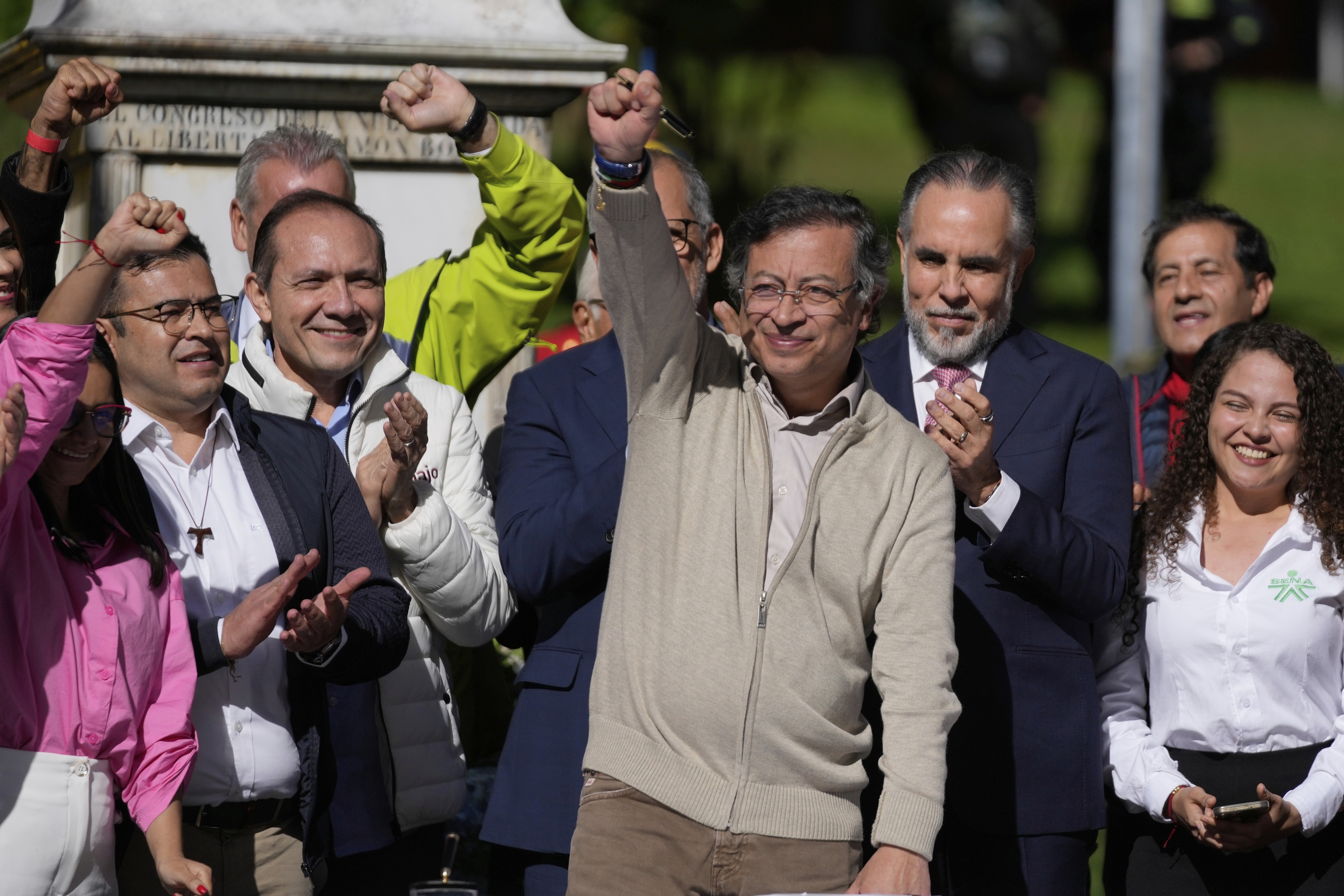 Colombia's President Gustavo Petro raises a fist before signing a labor reform bill into law in Bogota, Colombia, Wednesday, June 25, 2025. (AP Photo/Fernando Vergara)