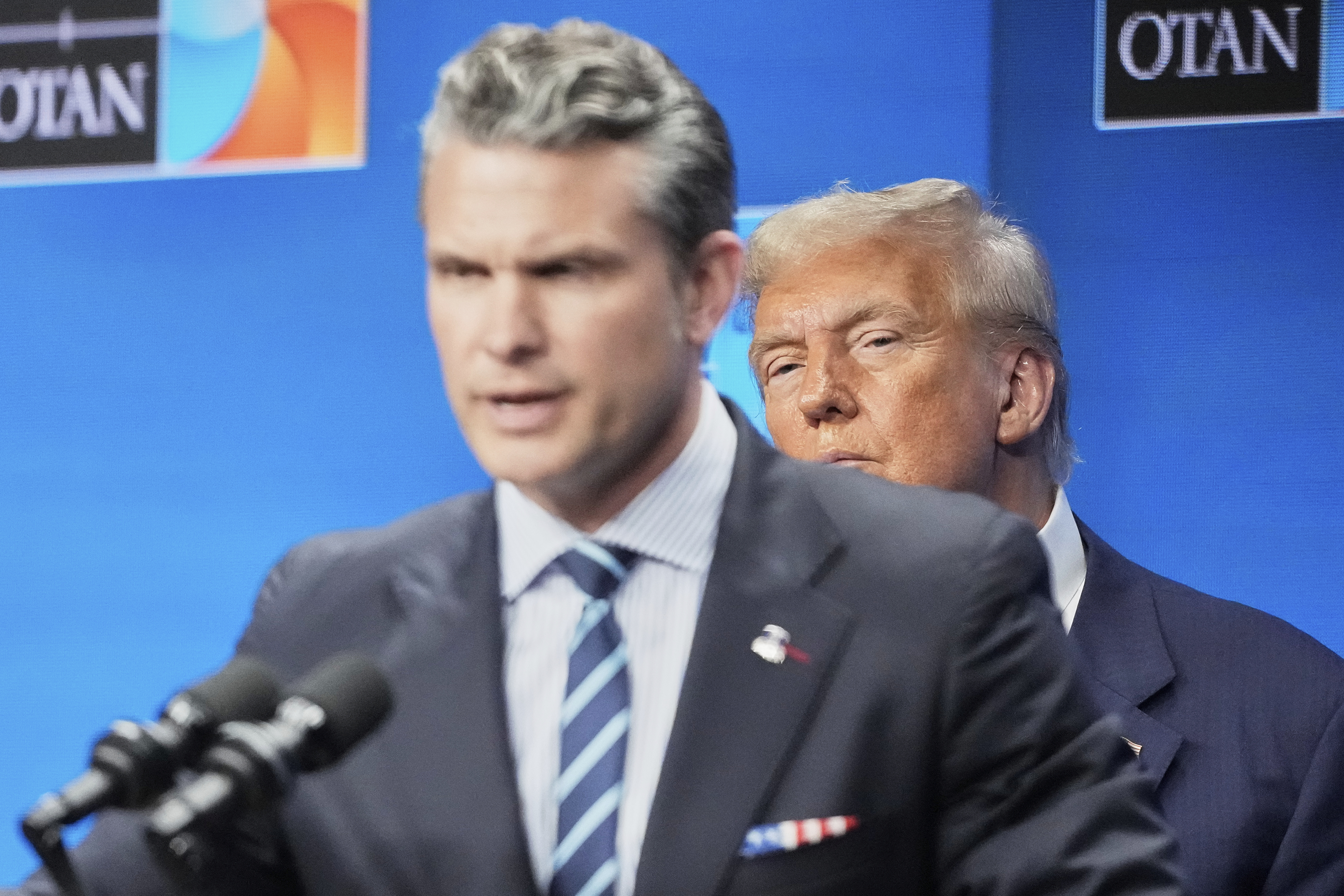 President Donald Trump watches Defense Secretary Pete Hegseth during a press conference after the plenary session at the NATO summit in The Hague, Netherlands, Wednesday, June 25, 2025. (AP Photo/Markus Schreiber)