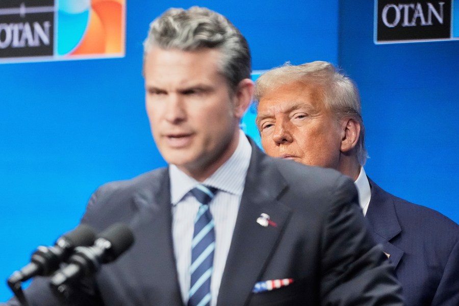President Donald Trump watches Defense Secretary Pete Hegseth during a press conference after the plenary session at the NATO summit in The Hague, Netherlands, Wednesday, June 25, 2025. (AP Photo/Markus Schreiber)