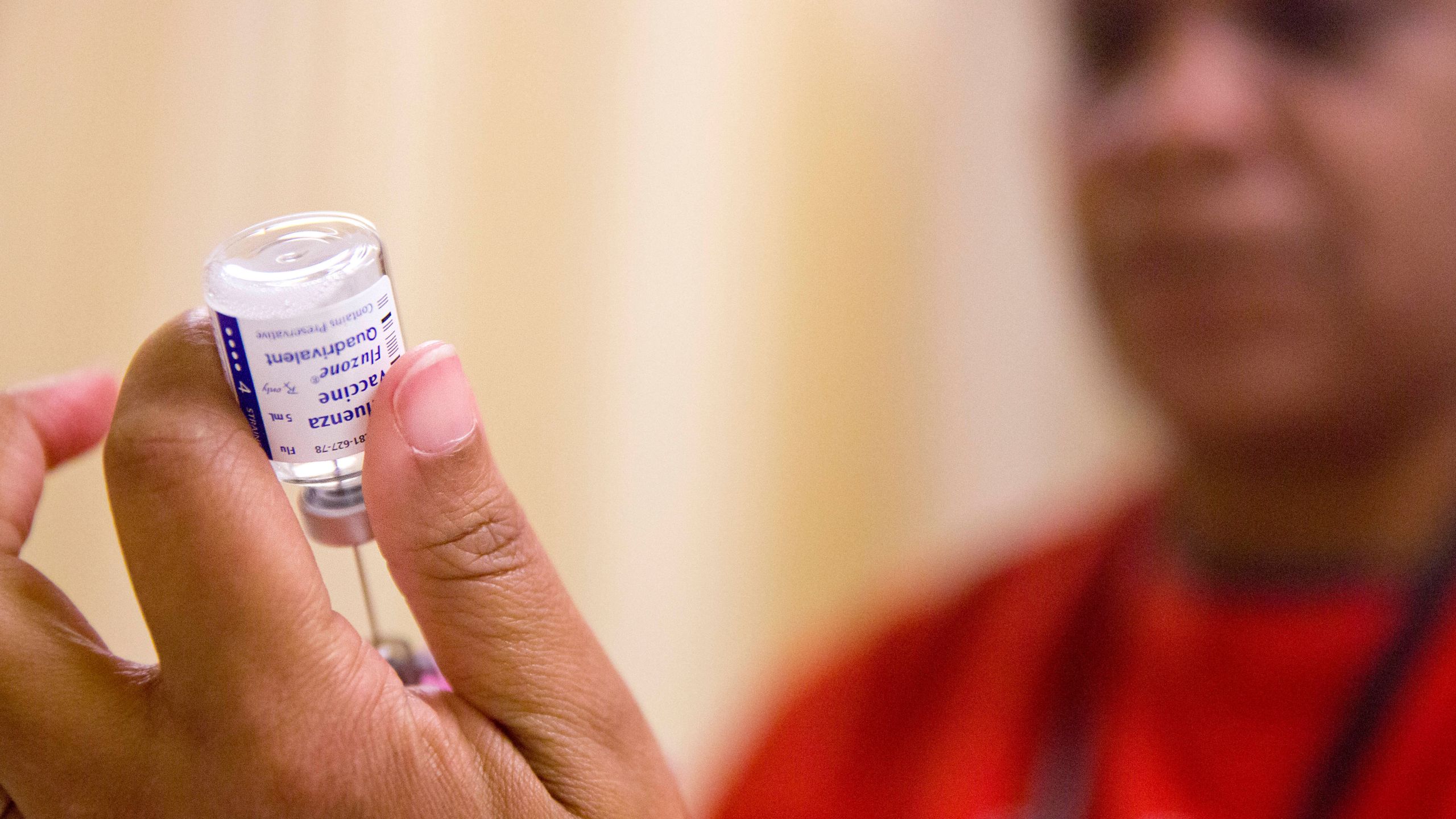FILE - A nurse prepares a flu shot from a vaccine vial at the Salvation Army in Atlanta, Feb. 7, 2018. (AP Photo/David Goldman, File)