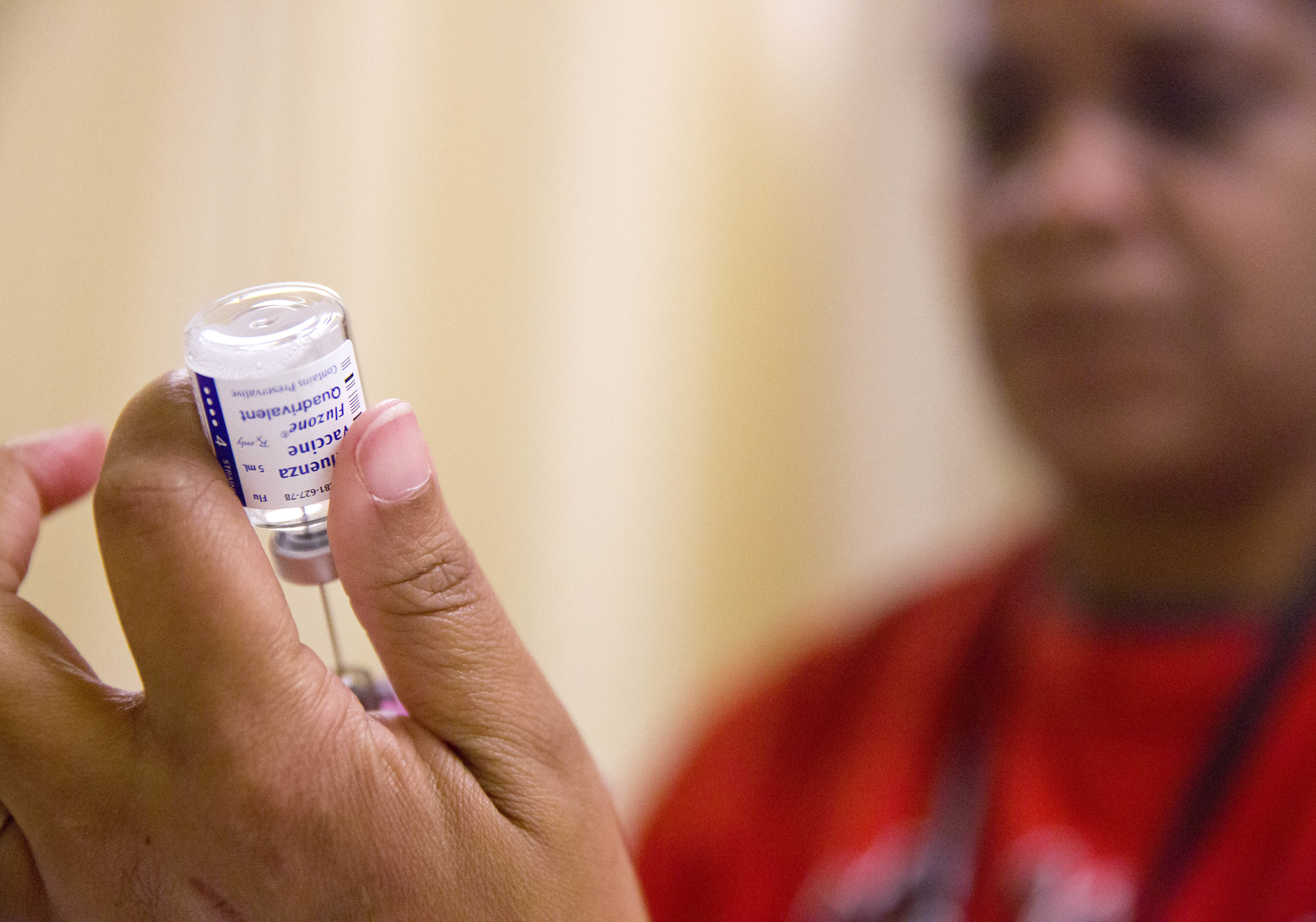 FILE - A nurse prepares a flu shot from a vaccine vial at the Salvation Army in Atlanta, Feb. 7, 2018. (AP Photo/David Goldman, File)