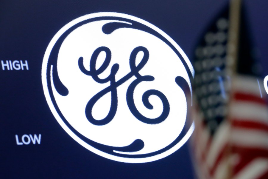 FILE - In this June 26, 2018, file photo the General Electric logo appears above a trading post on the floor of the New York Stock Exchange. (AP Photo/Richard Drew, File)