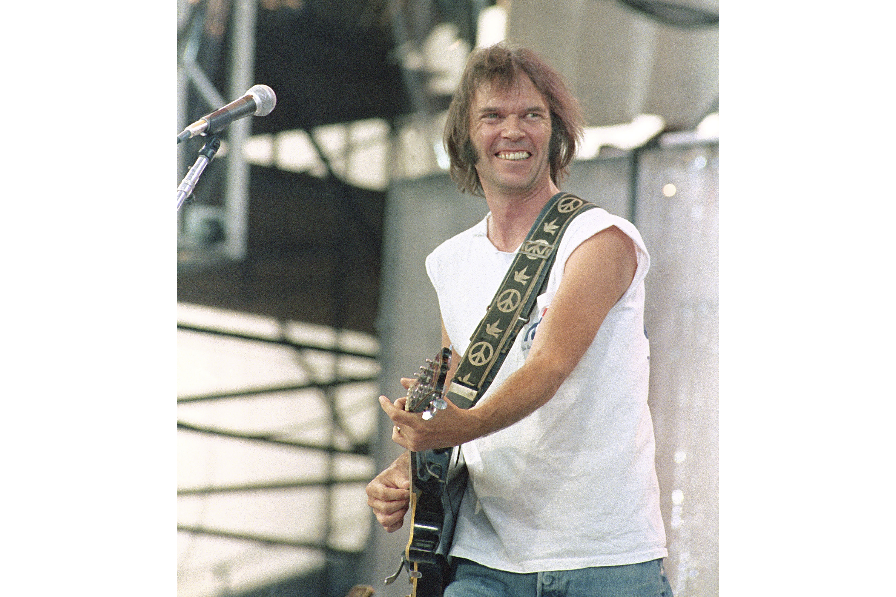 FILE - Neil Young performs during the Live Aid concert for famine relief at JFK Stadium in Philadelphia on July 13, 1985. (AP Photo/George Widman, File)