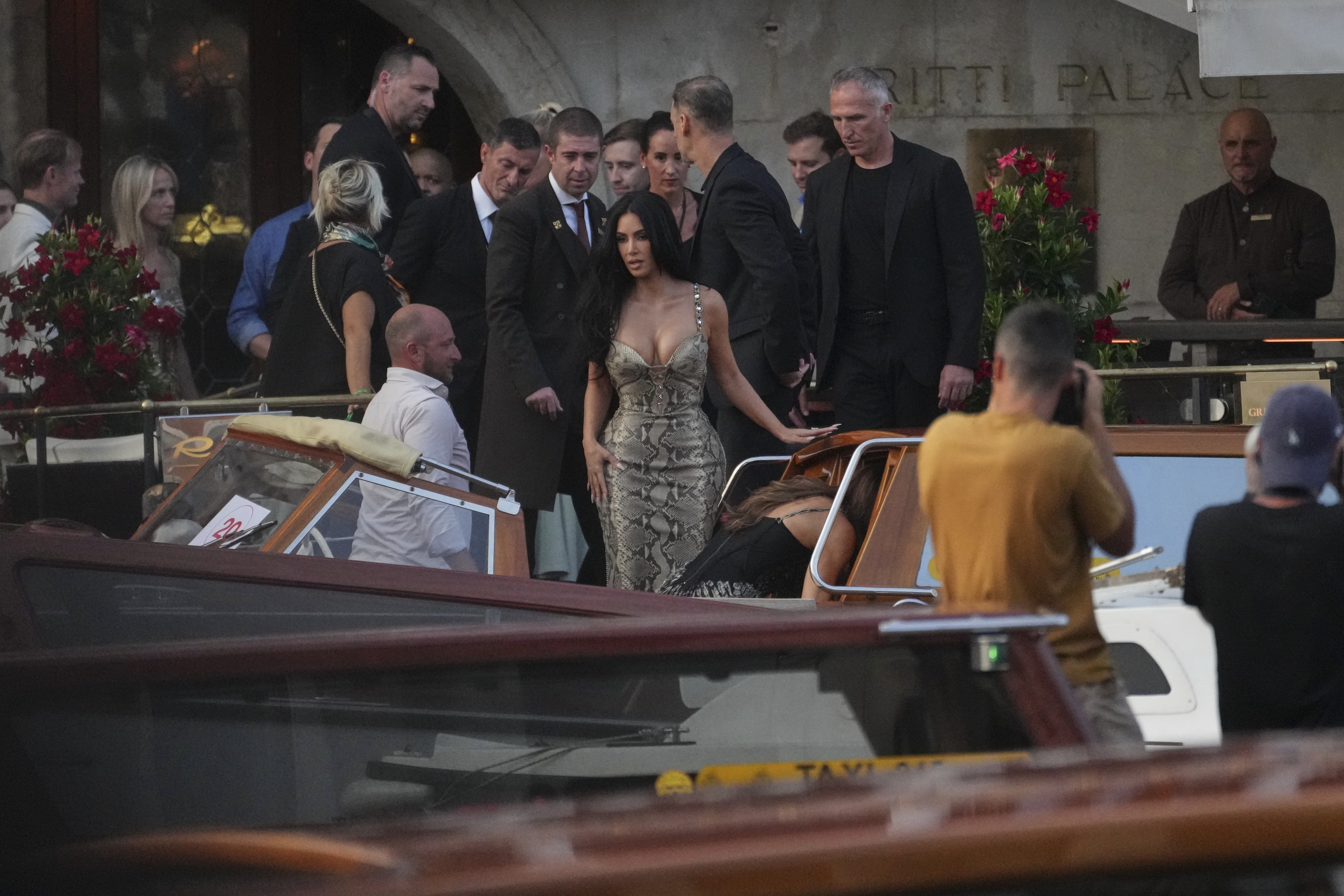 Kim Kardashian, center, leaves a hotel for the pre wedding reception of Amazon founder Jeff Bezos and Lauren Sanchez, in Venice, Italy, Thursday, June 26, 2025. (AP Photo/Antonio Calanni)