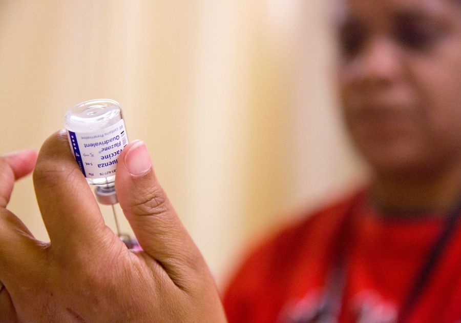 FILE - A nurse prepares a flu shot from a vaccine vial at the Salvation Army in Atlanta, Feb. 7, 2018. (AP Photo/David Goldman, File)