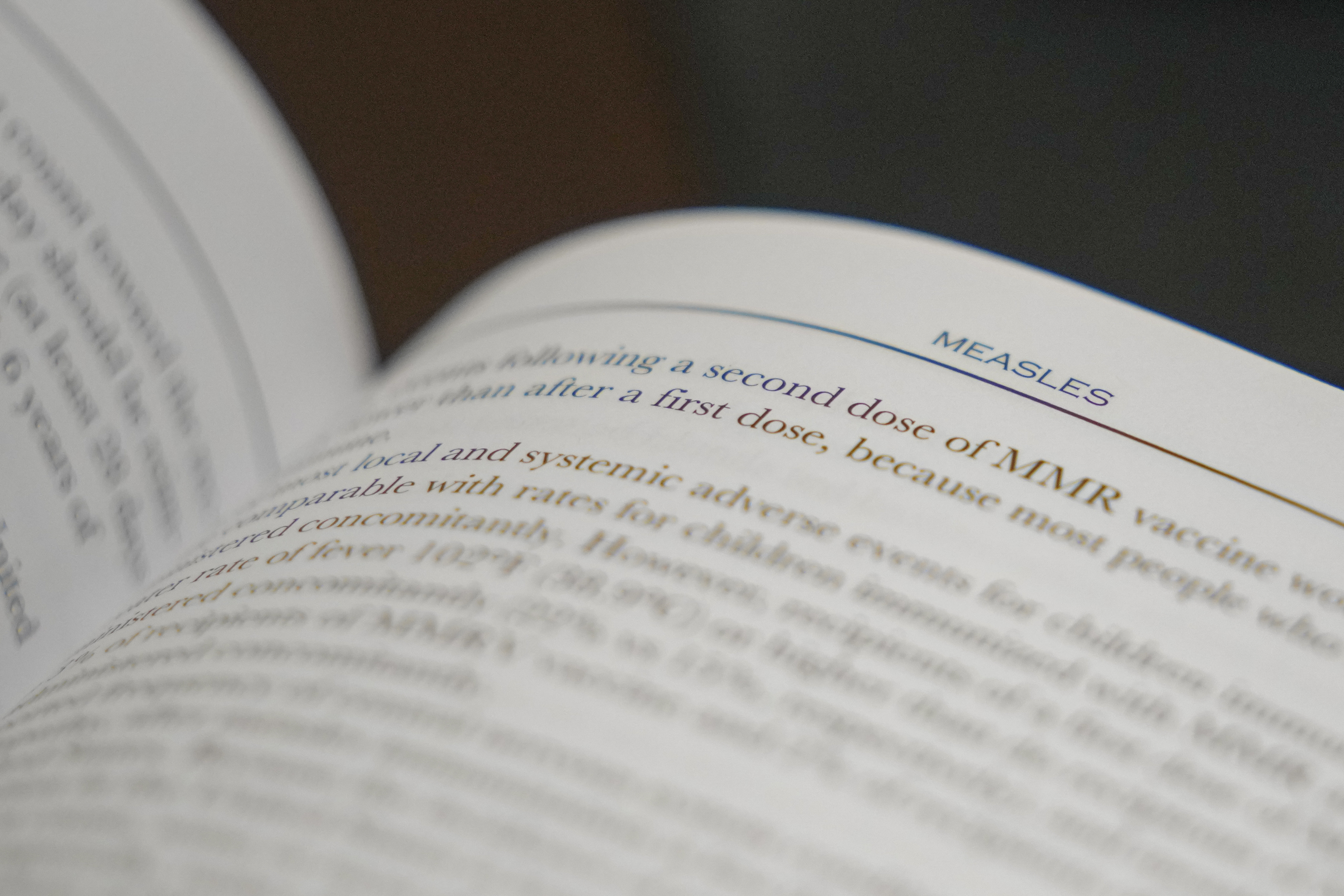 FILE - A section on measles is visible in the American Academy of Pediatrics Red Book seen at Hobbs Medical Clinic Monday, Feb. 24, 2025, in Hobbs, N.M. (AP Photo/Julio Cortez, File)