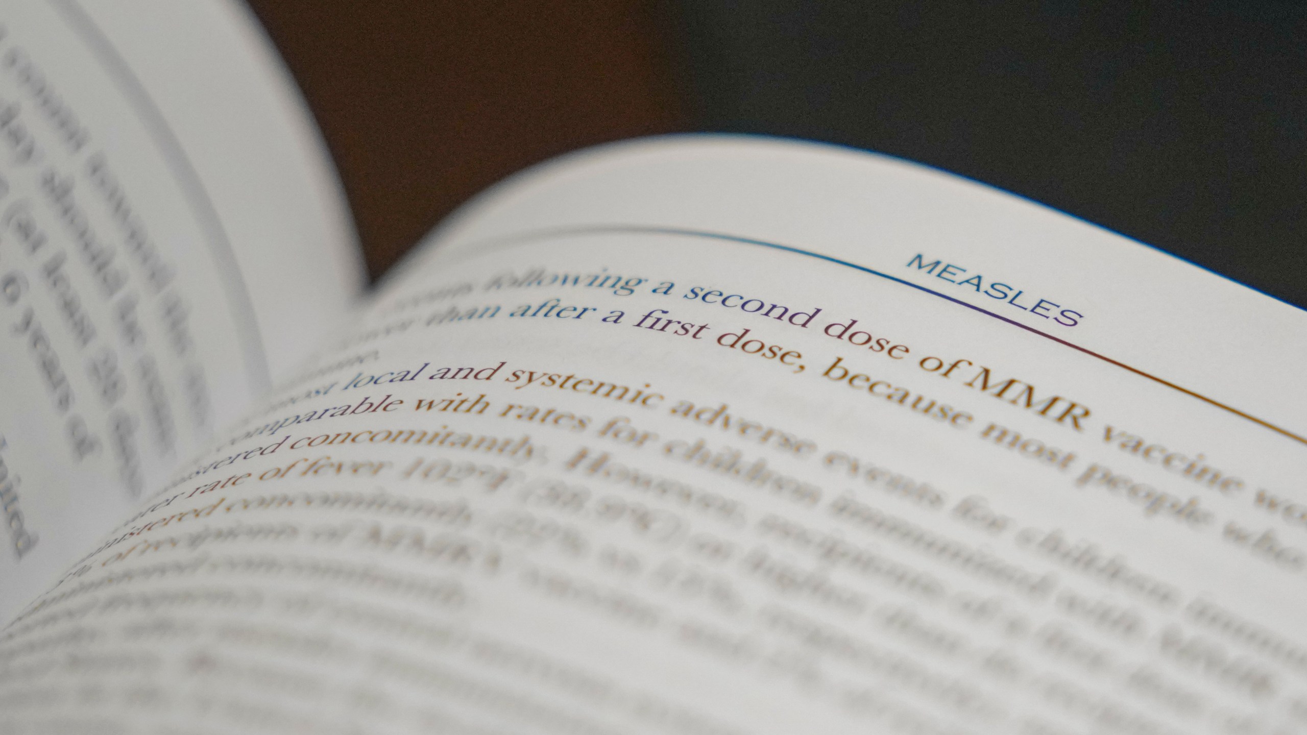 FILE - A section on measles is visible in the American Academy of Pediatrics Red Book seen at Hobbs Medical Clinic Monday, Feb. 24, 2025, in Hobbs, N.M. (AP Photo/Julio Cortez, File)