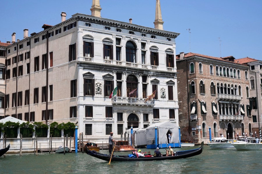 CORRECTS TO AMAN HOTEL NOT ANNAN A gondola sails past the Aman Hotel in Venice, Italy, on Thursday, June 26, 2025, ahead of festivities in the lagoon city reportedly linked to a wedding celebration for Jeff Bezos and Lauren Sánchez. (AP Photo/Antonio Calanni)