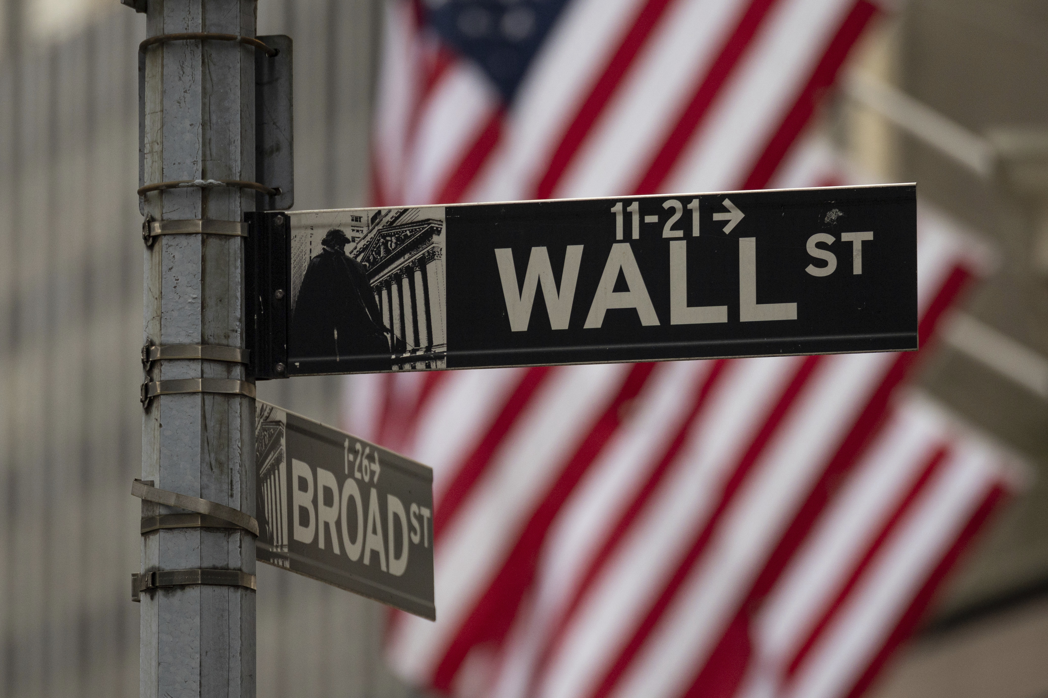 A Wall Street sign hangs near to the New York Stock Exchange, Wednesday, June 18, 2025, in New York. (AP Photo/Yuki Iwamura)