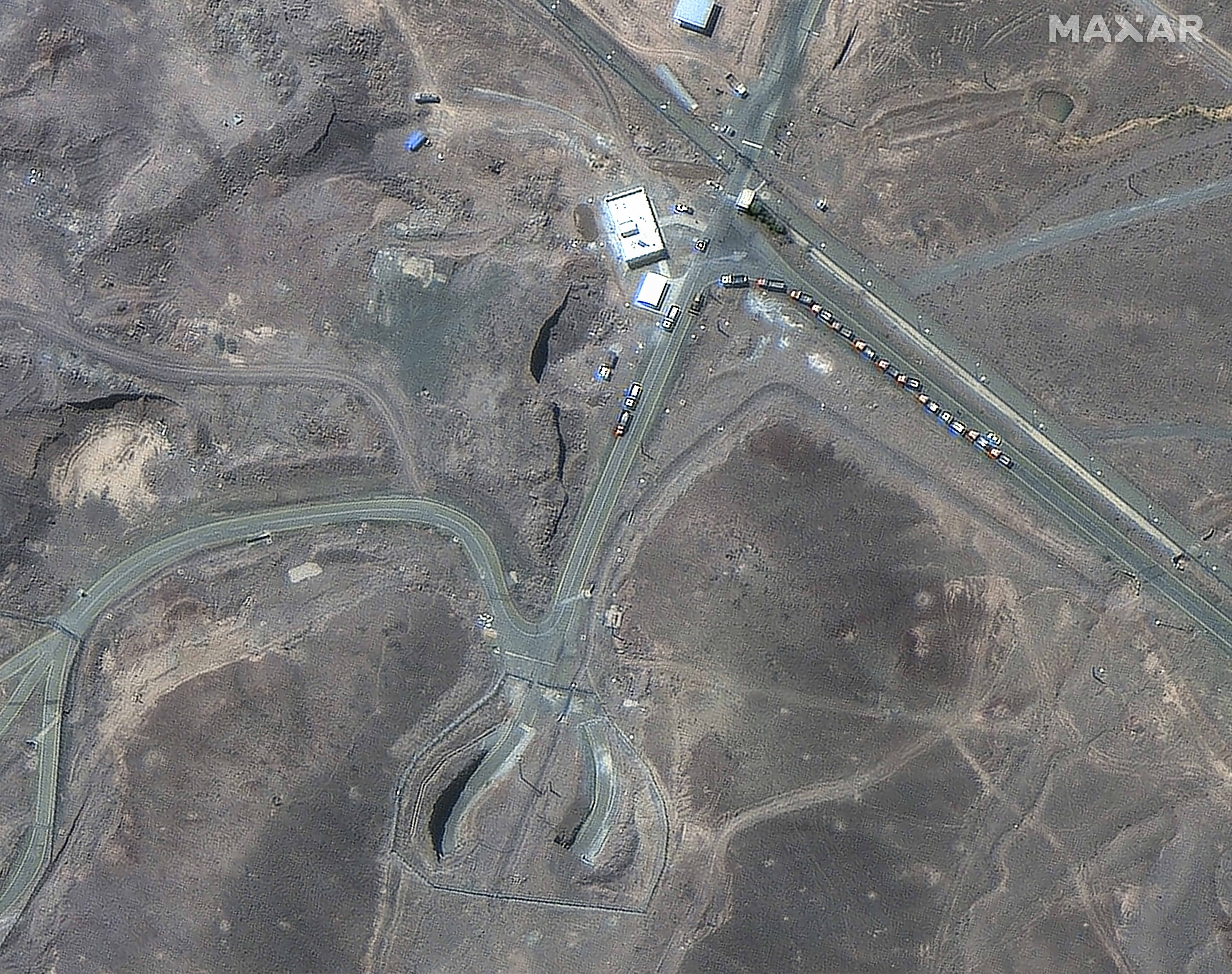 This satellite image provided by Maxar Technologies shows vehicles at the Fordo enrichment facility in Iran on June 19, 2025. (Maxar Technologies via AP)
