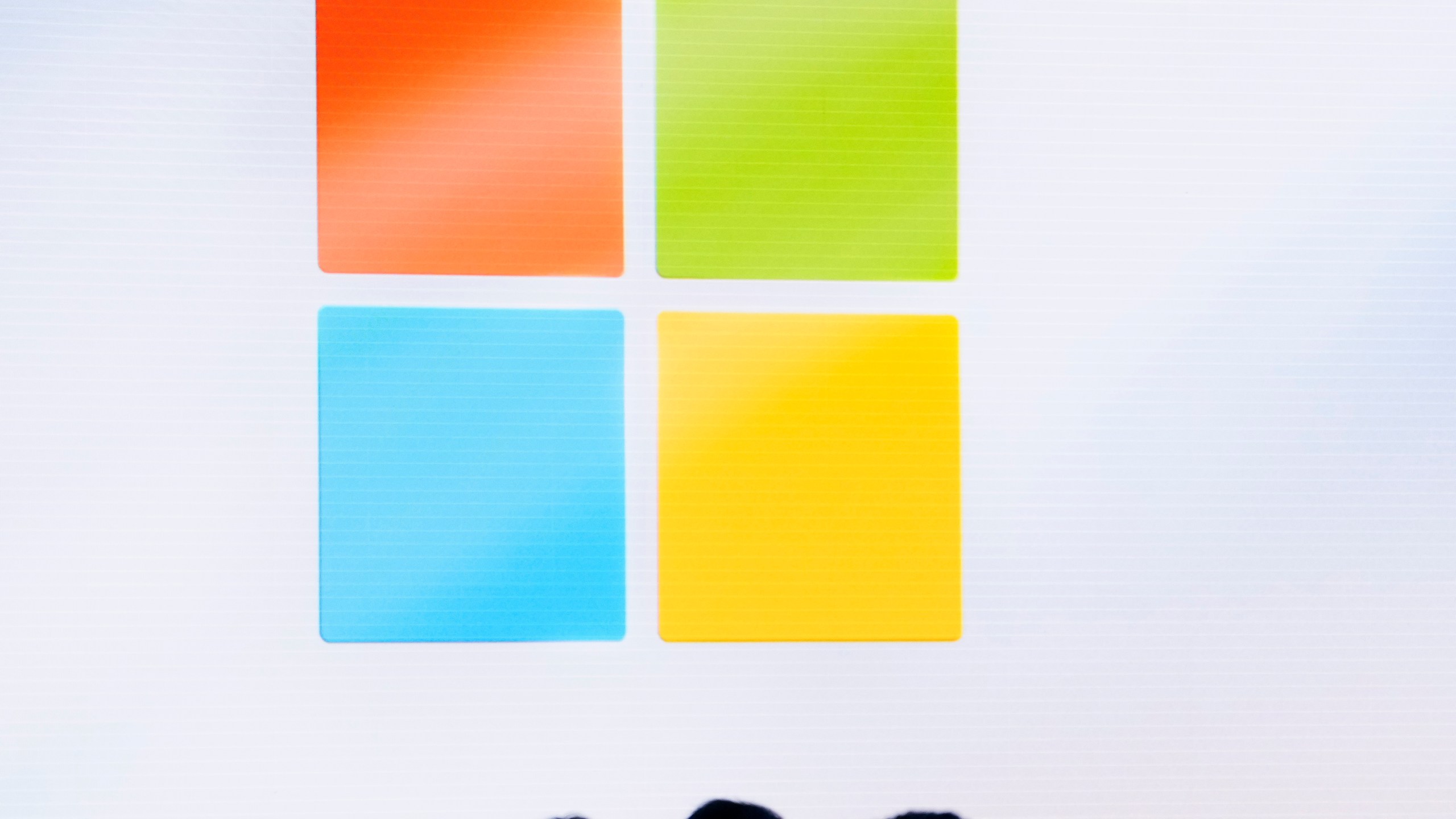 FILE - A Microsoft logo is seen on a screen as people listen at an event at Microsoft headquarters, May 20, 2024, in Redmond, Wash. (AP Photo/Lindsey Wasson, File)