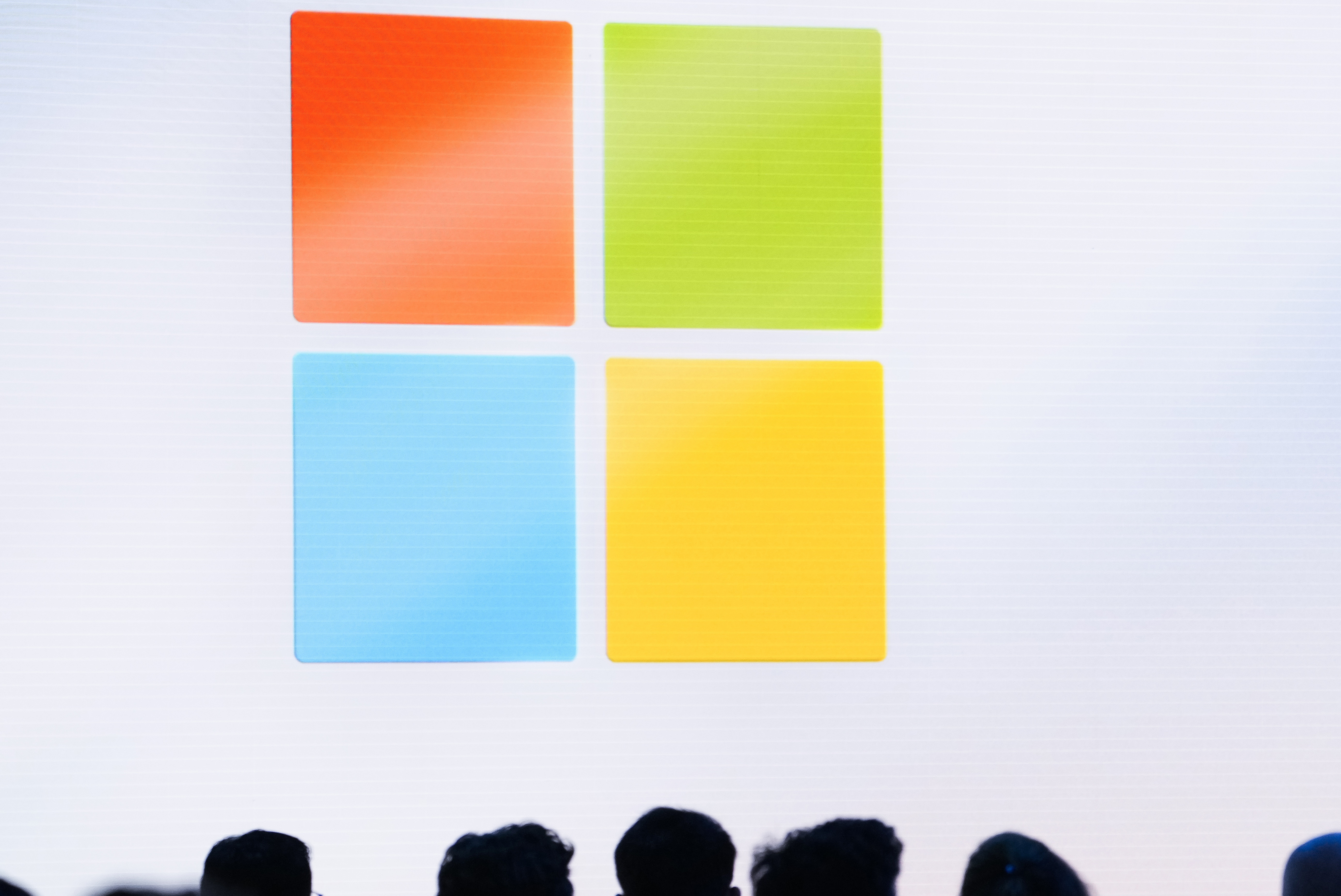 FILE - A Microsoft logo is seen on a screen as people listen at an event at Microsoft headquarters, May 20, 2024, in Redmond, Wash. (AP Photo/Lindsey Wasson, File)