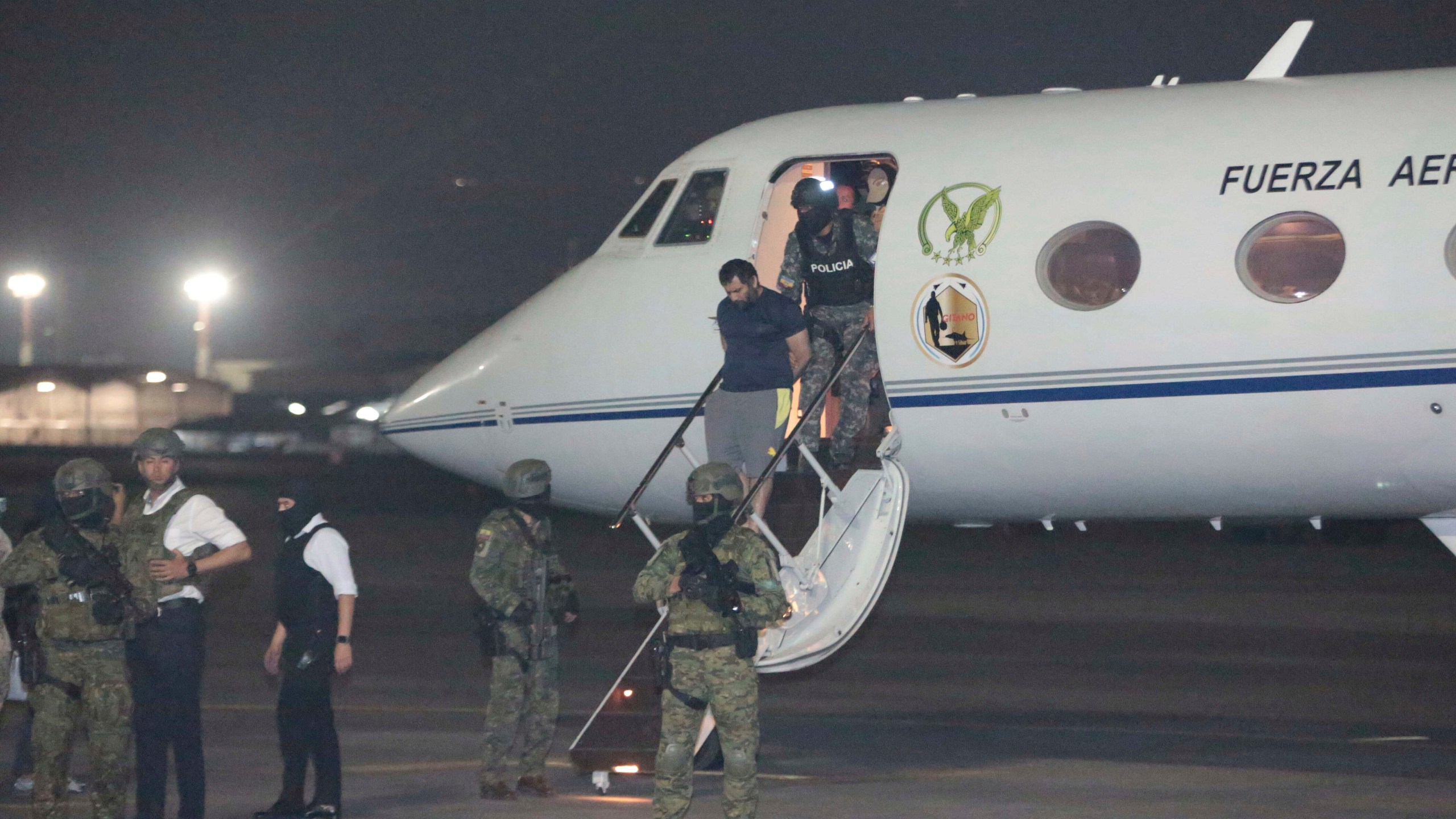 Escorted by soldiers and police officers, Adolfo "Fito" Macias, the leader of the Choneros gang, arrives in Guayaquil, Ecuador, after getting detained, Wednesday, June 25, 2025. (AP Photo/Joffre Flores)
