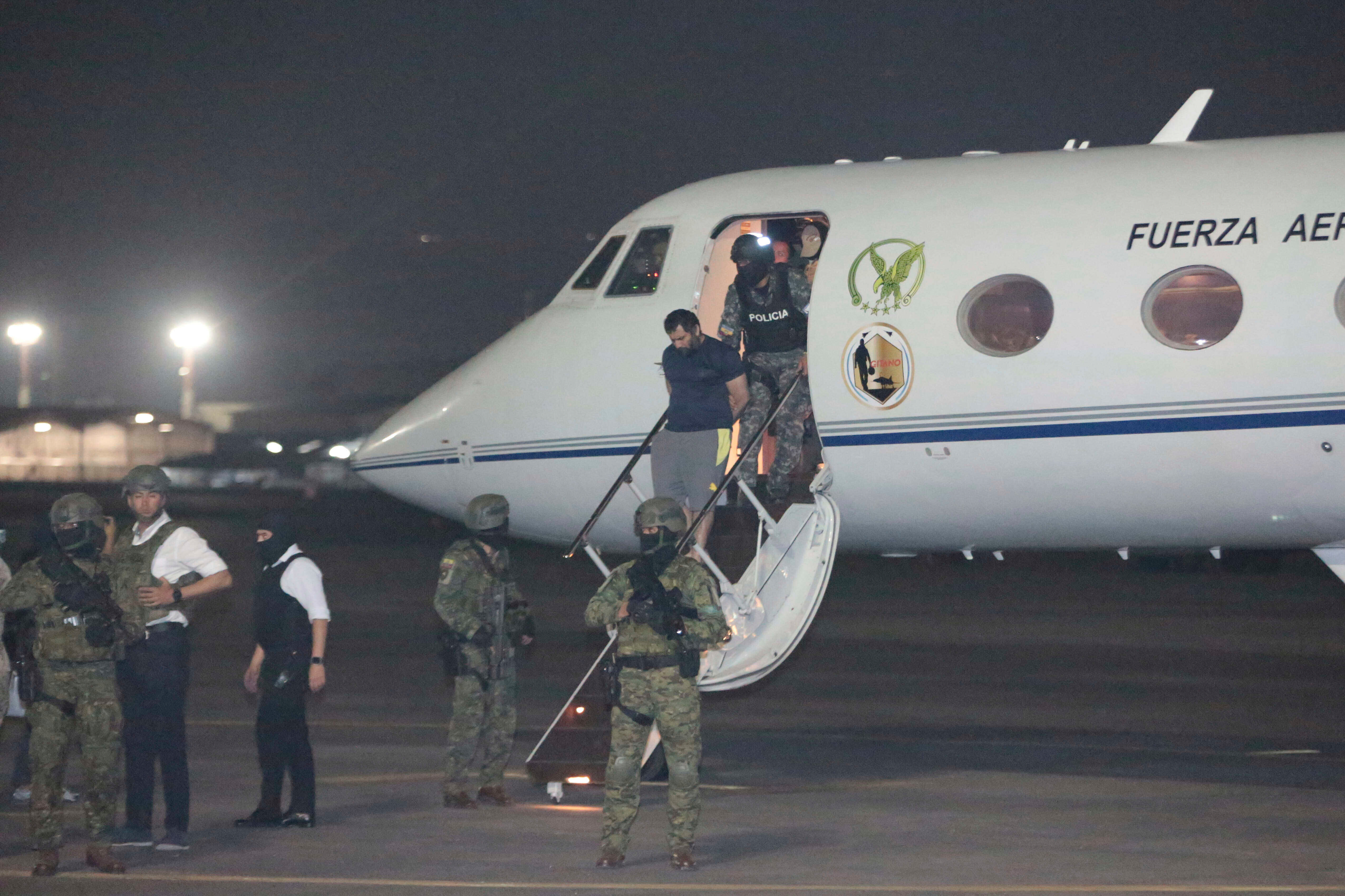 Escorted by soldiers and police officers, Adolfo "Fito" Macias, the leader of the Choneros gang, arrives in Guayaquil, Ecuador, after getting detained, Wednesday, June 25, 2025. (AP Photo/Joffre Flores)