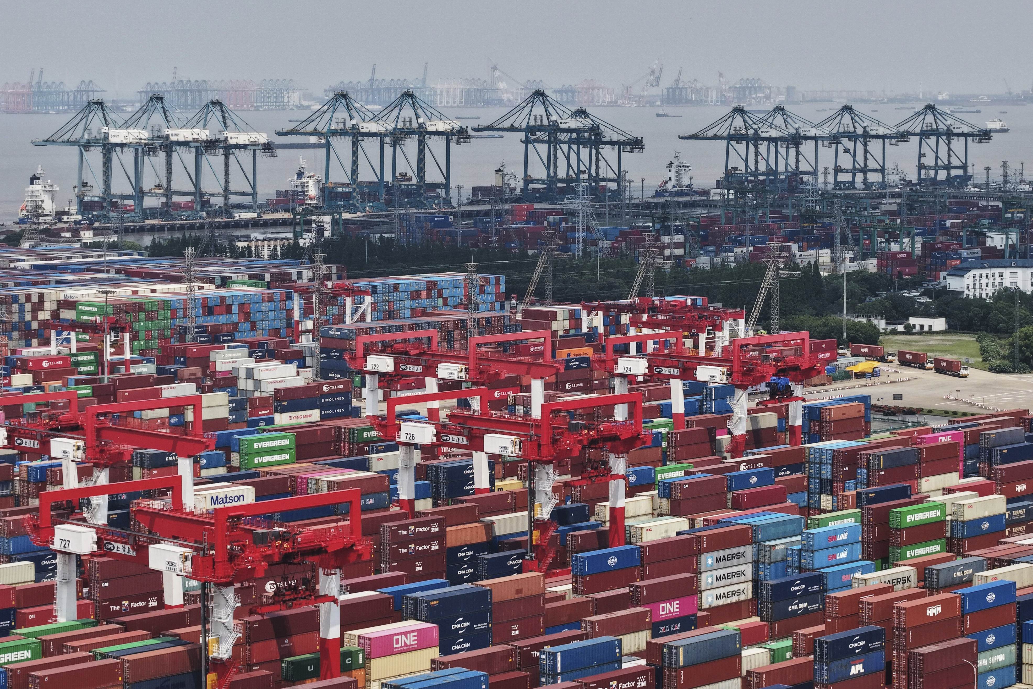 Trucks loaded with container move through a container terminal port in Shanghai, China Monday, June 9, 2025. (Chinatopix Via AP)