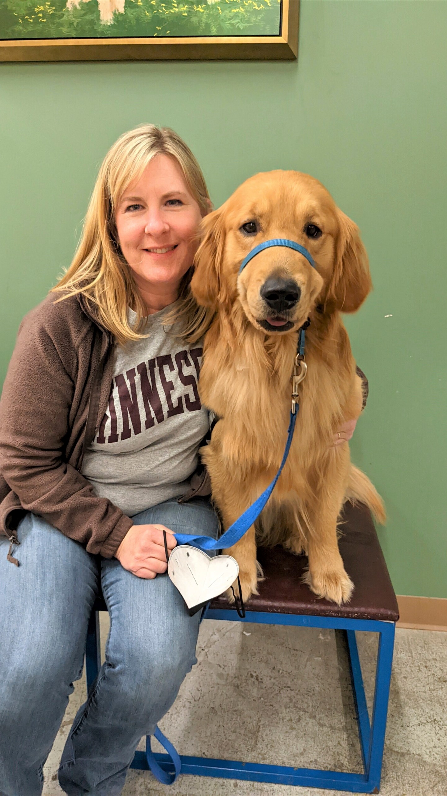 In this photo from 2022, provided by Helping Paws of Eden Prairie, Minn., state Rep. Melissa Hortman, DFL-Brooklyn Park, poses with Gilbert, a golden retriever trained to be a service dog but eventually adopted by the Hortman family, at a training facility in Hopkins, Minnesota. (Helping Paws via AP)