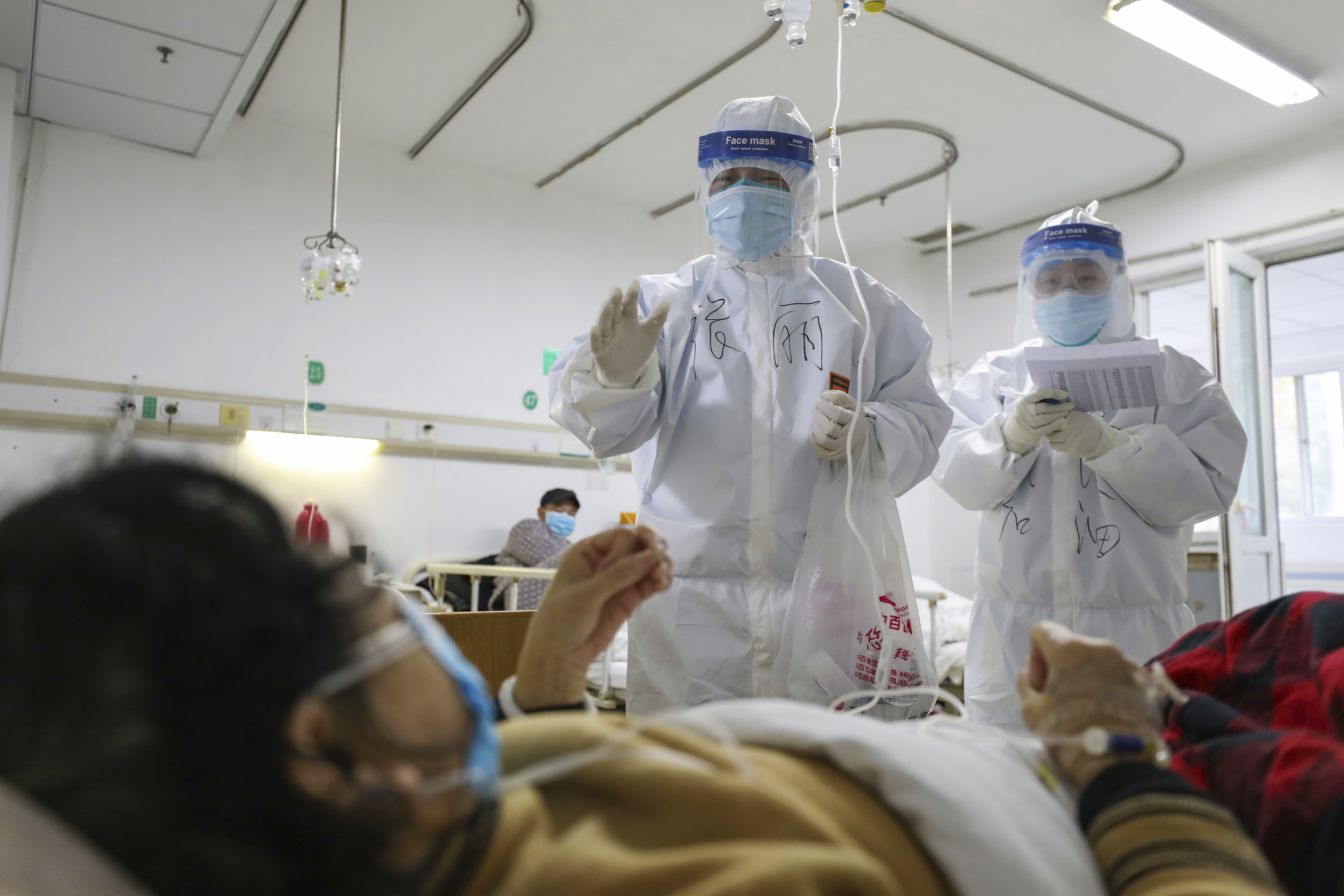 FILE - Medical workers check on patients in Jinyintan Hospital, designated for critical condition COVID-19 patients, in Wuhan, central China's Hubei province, Feb. 13, 2020. (Chinatopix Via AP, File)