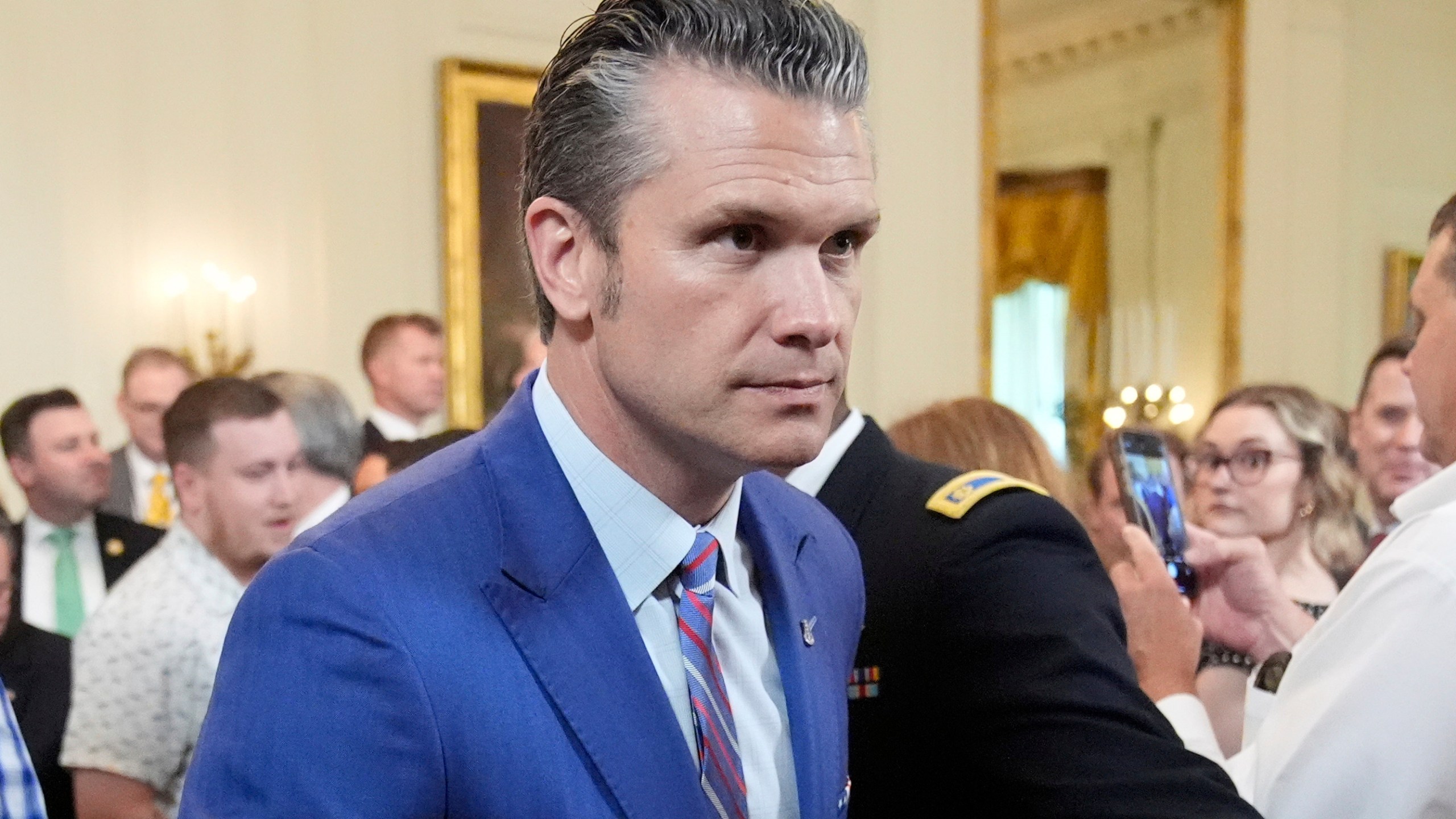 Defense Secretary Pete Hegseth departs an event to promote President Donald Trump's domestic policy and budget agenda in the East Room of the White House, Thursday, June 26, 2025, in Washington. (AP Photo/Mark Schiefelbein)