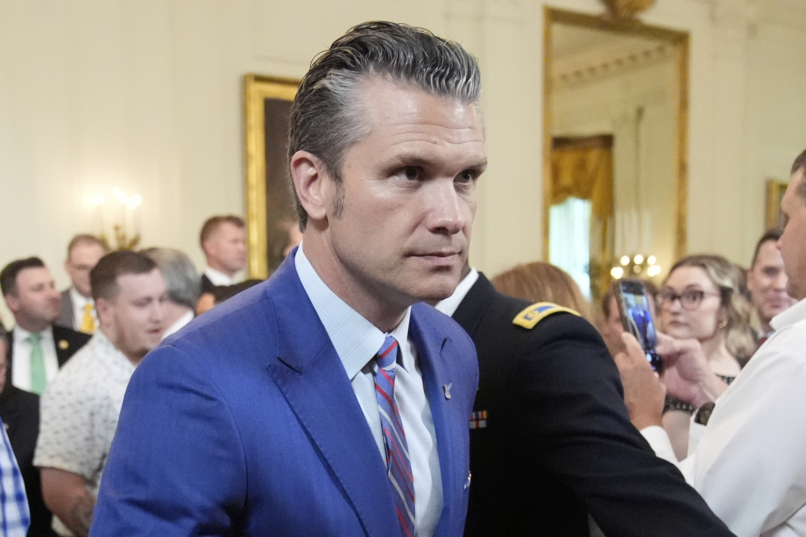 Defense Secretary Pete Hegseth departs an event to promote President Donald Trump's domestic policy and budget agenda in the East Room of the White House, Thursday, June 26, 2025, in Washington. (AP Photo/Mark Schiefelbein)