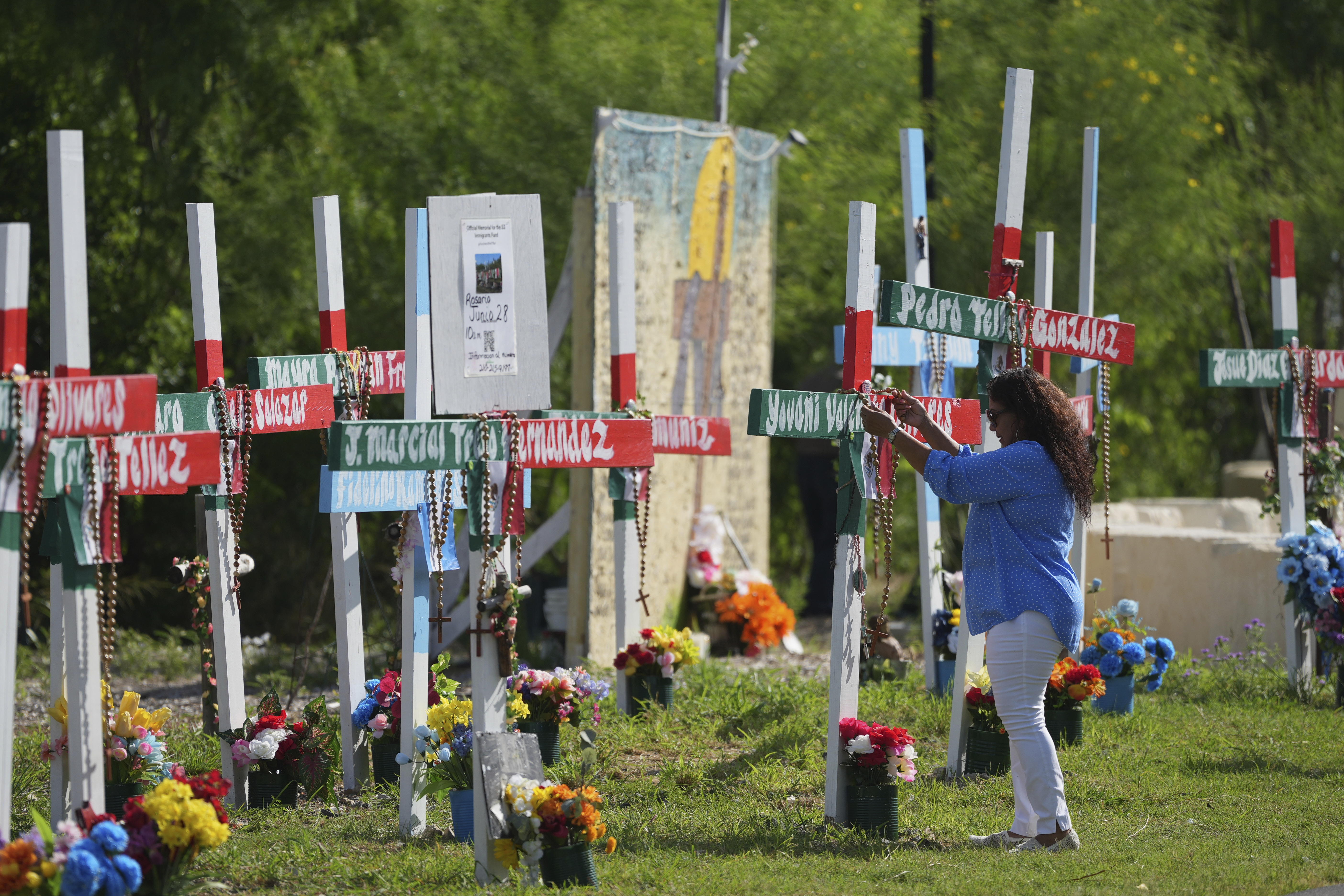 Angelita Olvera visits a memorial honoring the victims and survivors of a human smuggling tragedy where dozens of migrants were found in an airless tractor-trailer rig two years ago, in San Antonio, Friday, June 27, 2025. (AP Photo/Eric Gay)