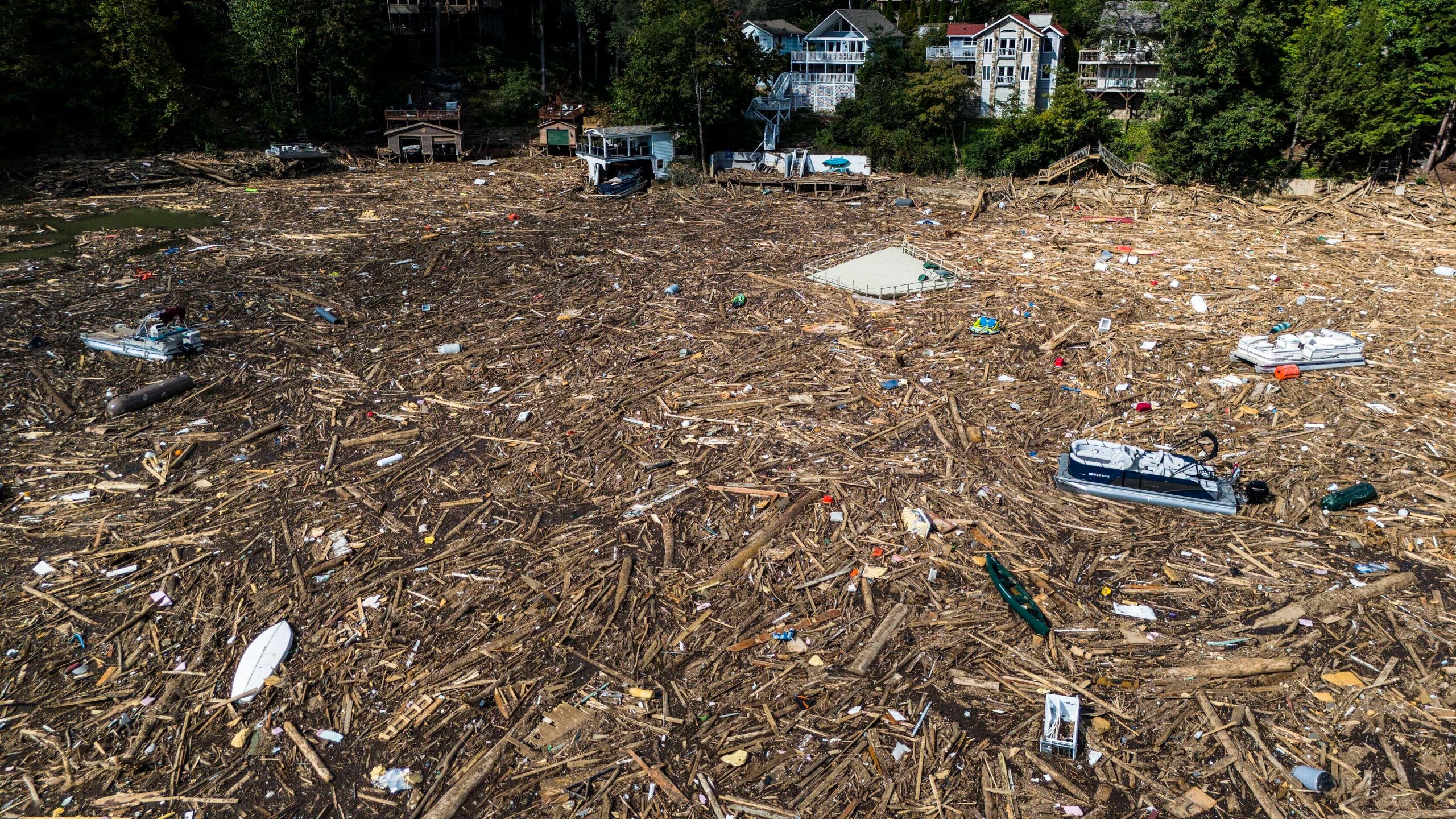 FILE - Debris is strewn on the lake in the aftermath of Hurricane Helene, Oct. 2, 2024, in Lake Lure, N.C. (AP Photo/Mike Stewart, File)