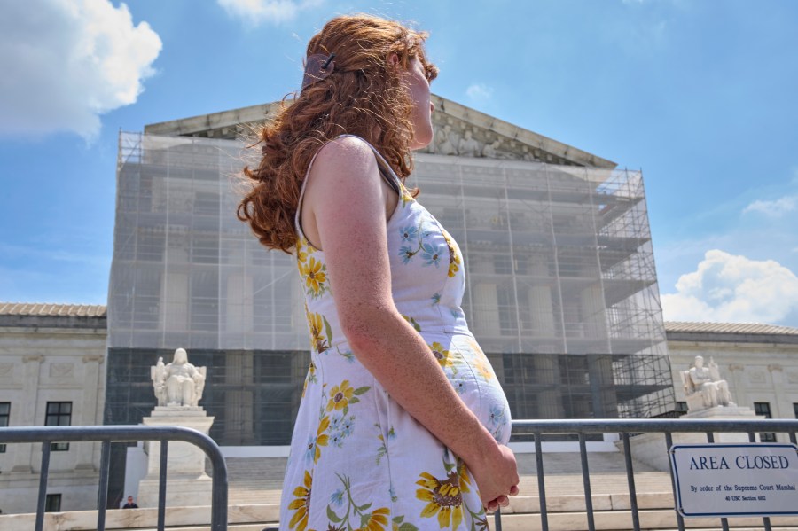 FILE - Mairelise Robinson, a U.S. citizen who is 6 months pregnant, attends a protest in support of birthright citizenship, outside of the Supreme Court in Washington, May 15, 2025. (AP Photo/Jacquelyn Martin, File)