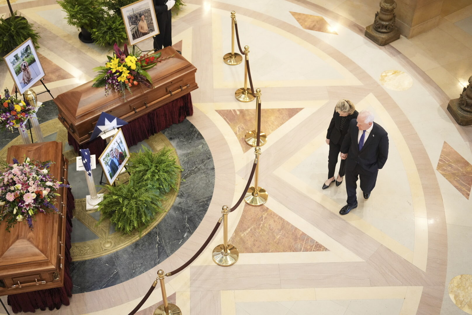Gov. Tim Walz and his wife Gwen Walz walk into the rotunda to pay their respect to former Minnesota House Speaker Melissa Hortman, who will lie in state with her husband, Mark, and their golden retriever, Gilbert at the Minnesota Capitol rotunda on Friday, June 17, 2025 in St. Paul, Minn. (Alex Kormann/Star Tribune via AP)