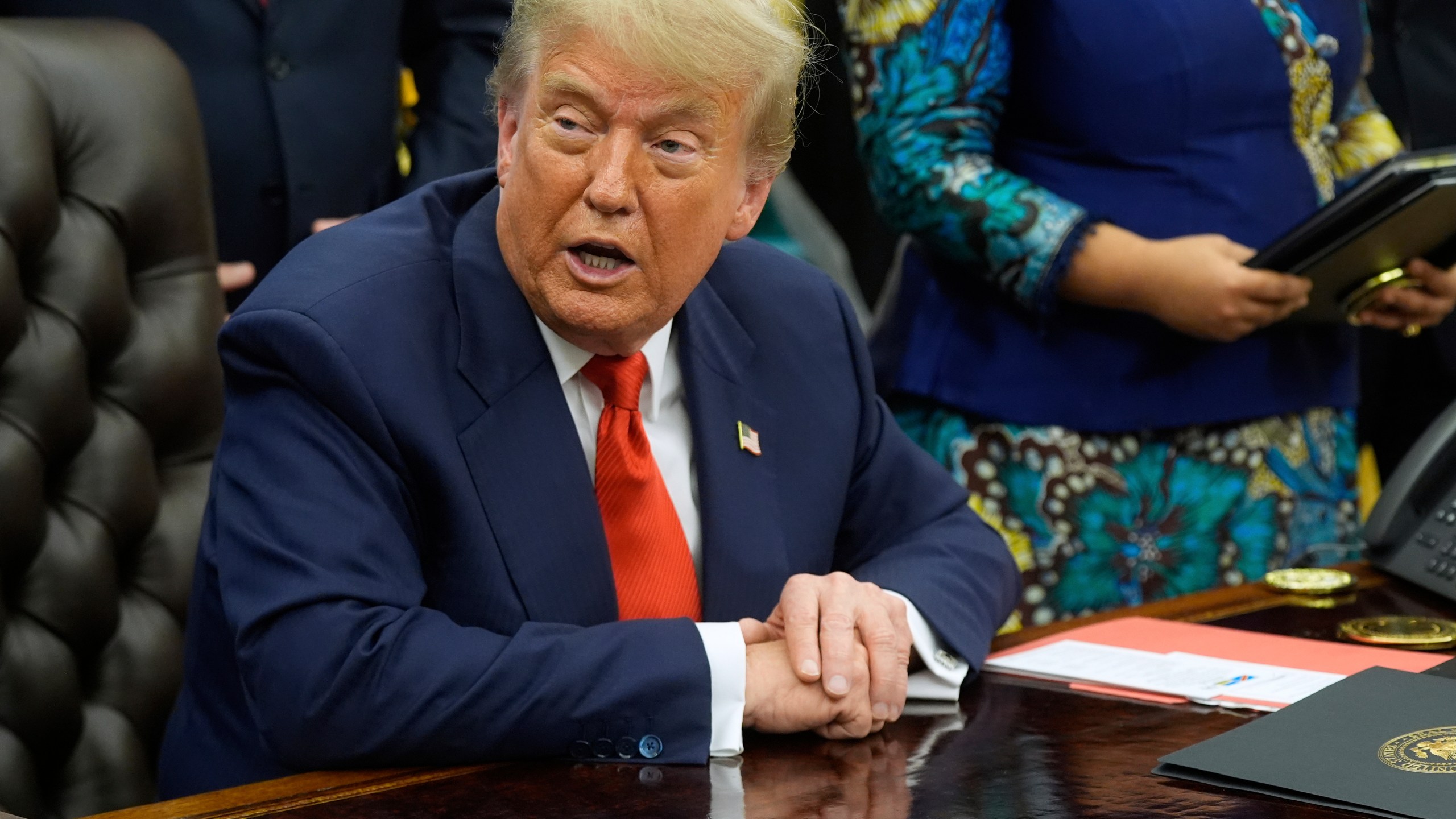 President Donald Trump answers questions from reporters as he meets with Congo's Foreign Minister Therese Kayikwamba Wagner, and Rwanda's Foreign Minister Olivier Nduhungirehe, Friday, June 27, 2025, in the Oval Office at the White House in Washington. (AP Photo/Manuel Balce Ceneta)