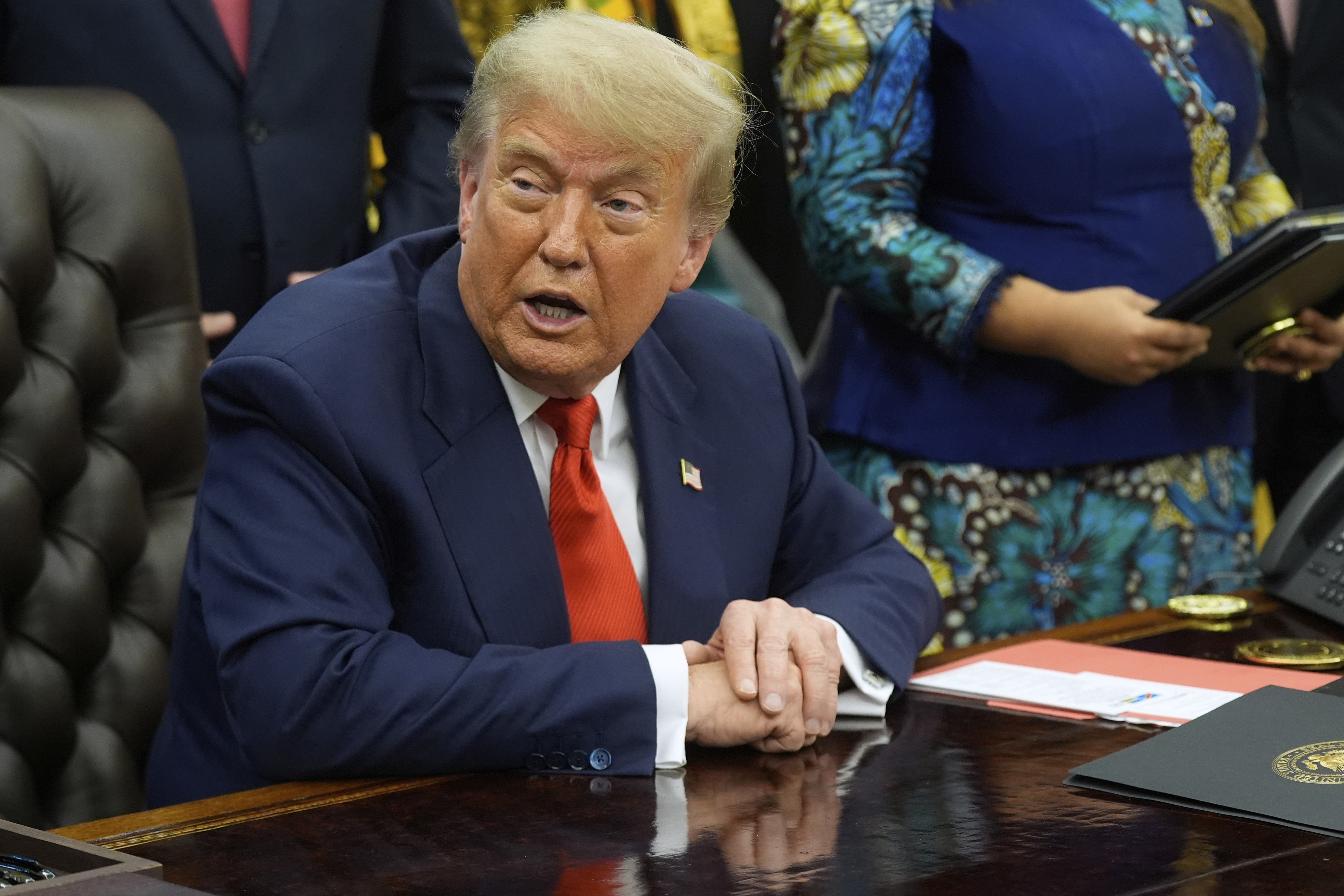 President Donald Trump answers questions from reporters as he meets with Congo's Foreign Minister Therese Kayikwamba Wagner, and Rwanda's Foreign Minister Olivier Nduhungirehe, Friday, June 27, 2025, in the Oval Office at the White House in Washington. (AP Photo/Manuel Balce Ceneta)