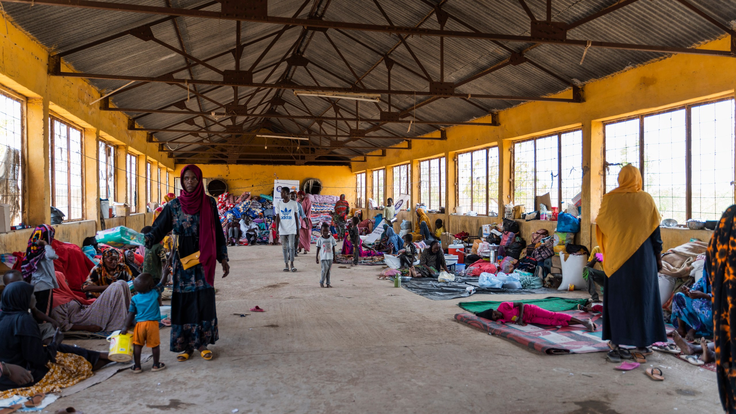 This June 2023 photo provided by the World Food Program shows internally displaced persons at the Wad Almajzoub farm camp in Wad Medani, Gezira state, Sudan. (Ala Kheir/U.N. Office for the Coordination of Humanitarian Affairs via AP)