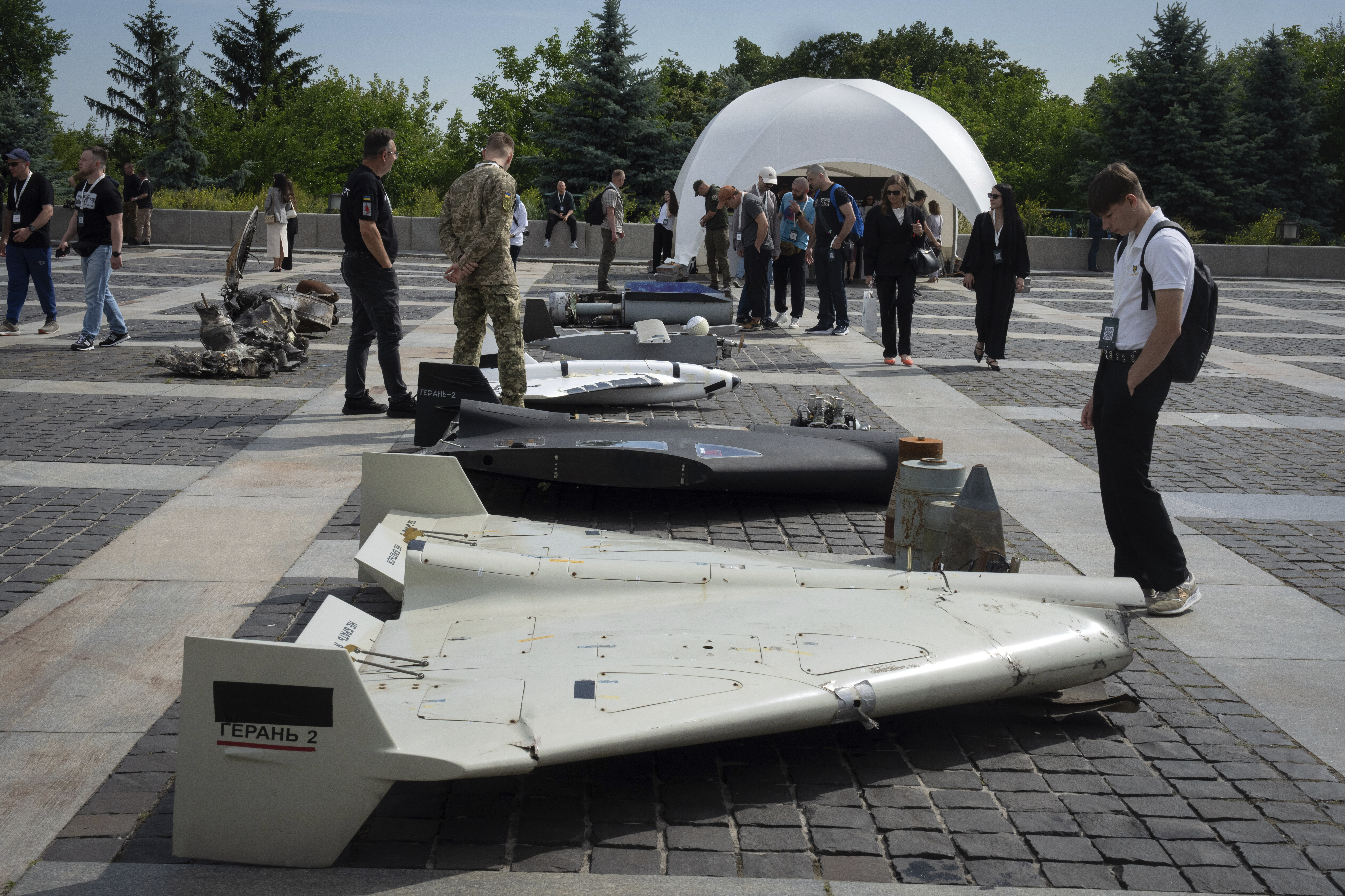 Visitors check damaged Russian drones during the International Conference on Expanding Sanctions Against Russia in Kyiv, Ukraine, Friday, June 27, 2025. (AP Photo/Efrem Lukatsky)