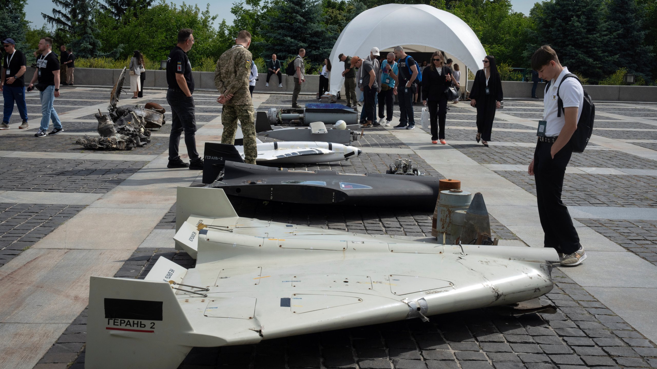 Visitors check damaged Russian drones during the International Conference on Expanding Sanctions Against Russia in Kyiv, Ukraine, Friday, June 27, 2025. (AP Photo/Efrem Lukatsky)