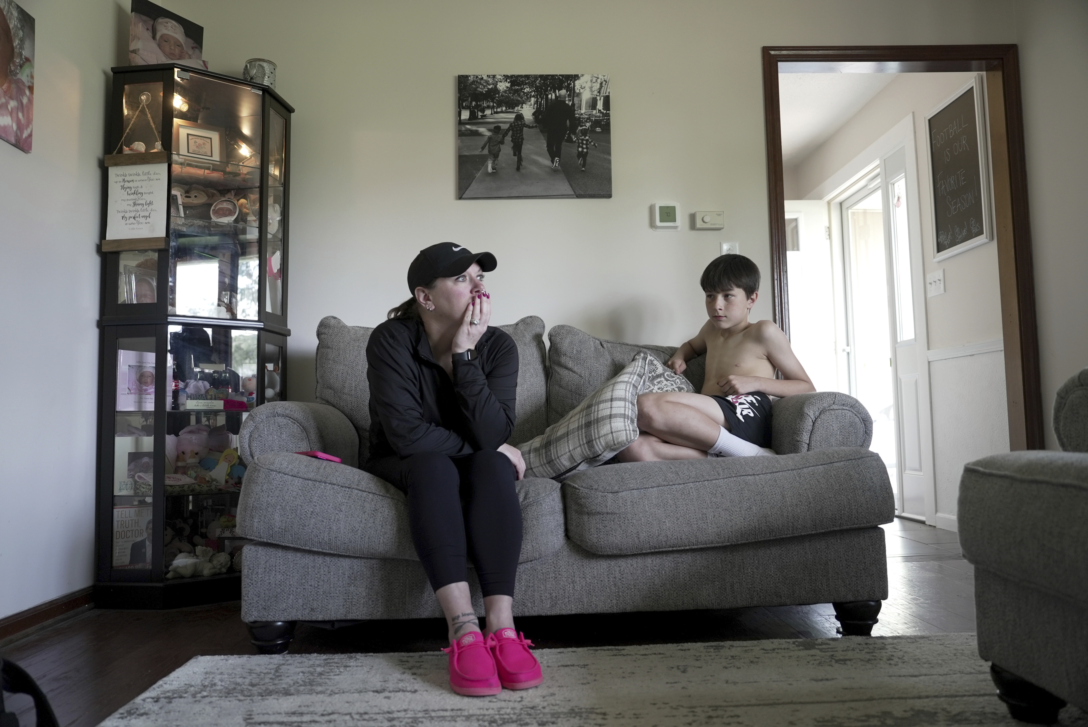 Katie Van Tornhout sits with her son, Cain, at home in Lakeville, Ind., on May 7, 2025. (AP Photo/Shelby Lum)