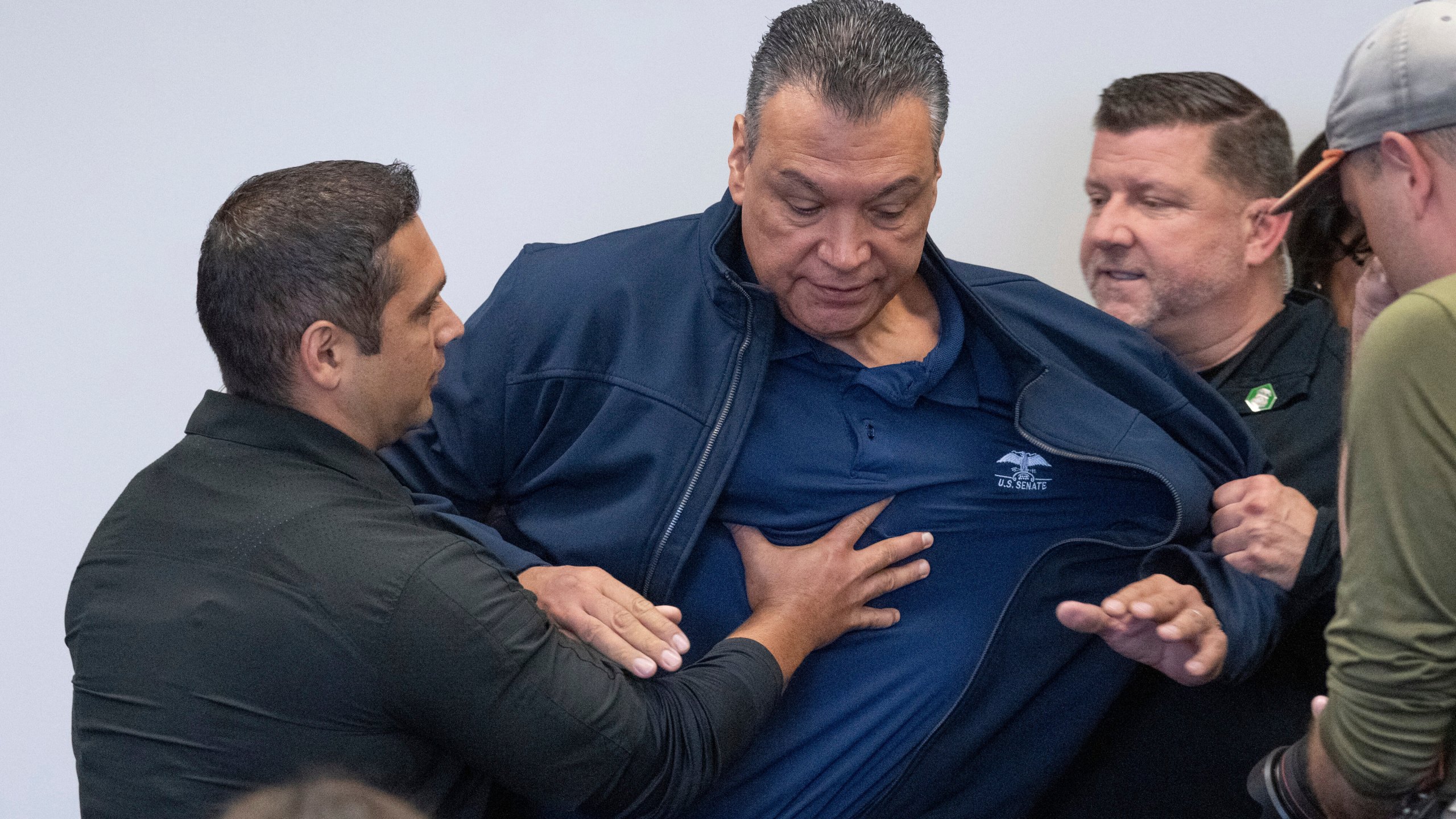 U.S. Sen. Alex Padilla, D-Calif., is pushed out of the room as Homeland Security Secretary Kristi Noem holds a news conference regarding the recent protests in Los Angeles, Thursday, June 12, 2025. (David Crane/The Orange County Register via AP)