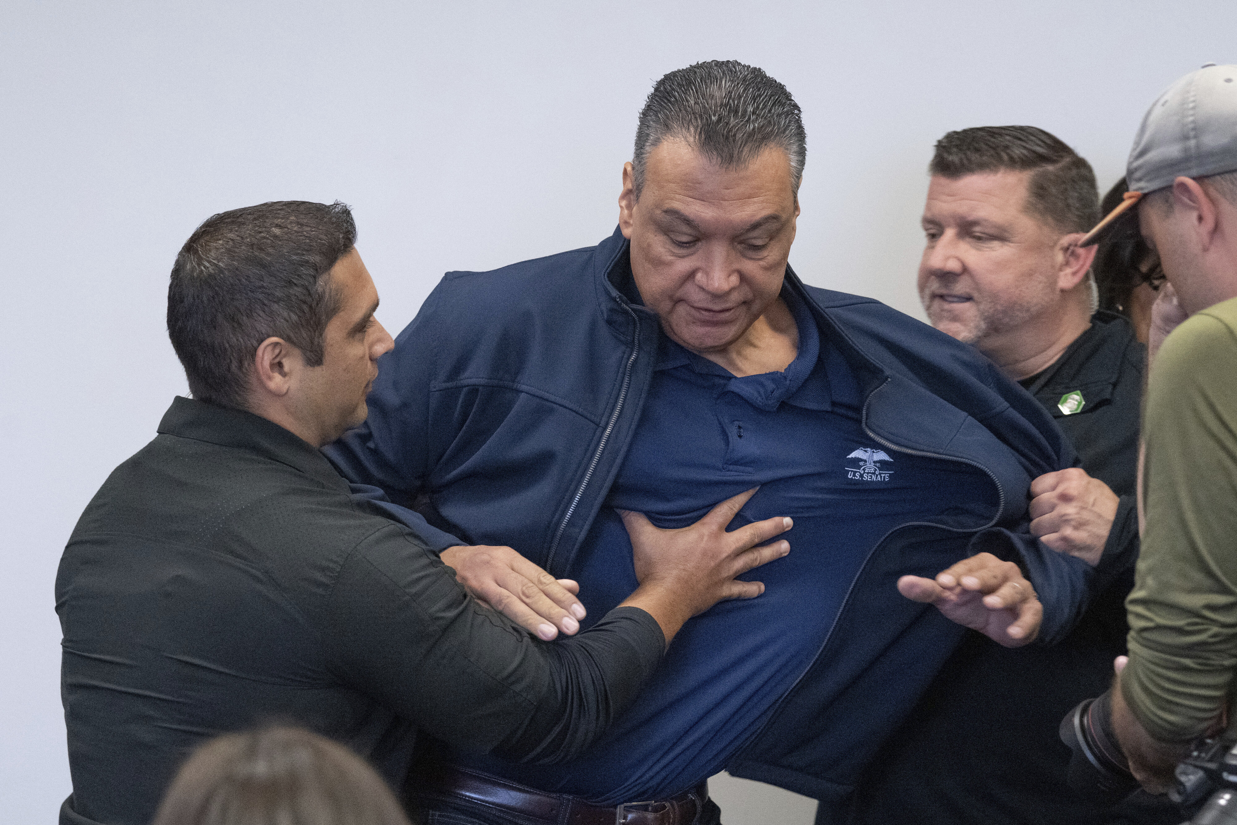 U.S. Sen. Alex Padilla, D-Calif., is pushed out of the room as Homeland Security Secretary Kristi Noem holds a news conference regarding the recent protests in Los Angeles, Thursday, June 12, 2025. (David Crane/The Orange County Register via AP)